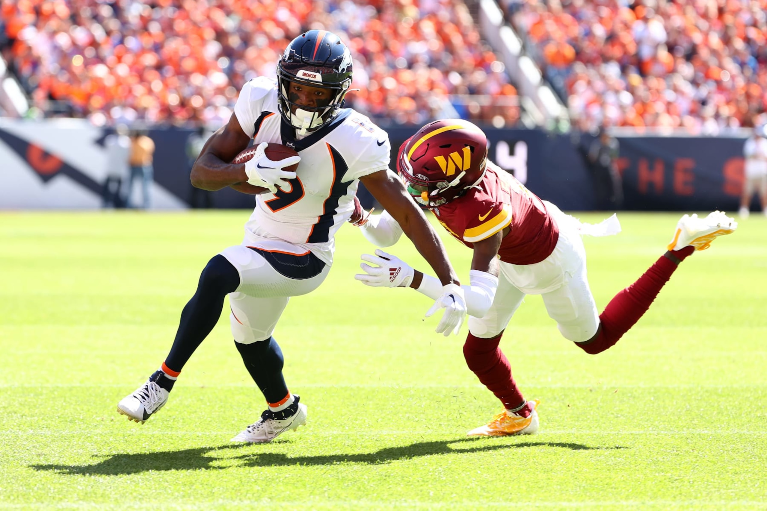 DENVER, COLORADO - SEPTEMBER 17: Marvin Mims Jr. #19 of the Denver Broncos runs past Kendall Fuller #29 of the Washington Commanders during the first quarter at Empower Field At Mile High on September 17, 2023 in Denver, Colorado. (Photo by Jamie Schwaberow/Getty Images)