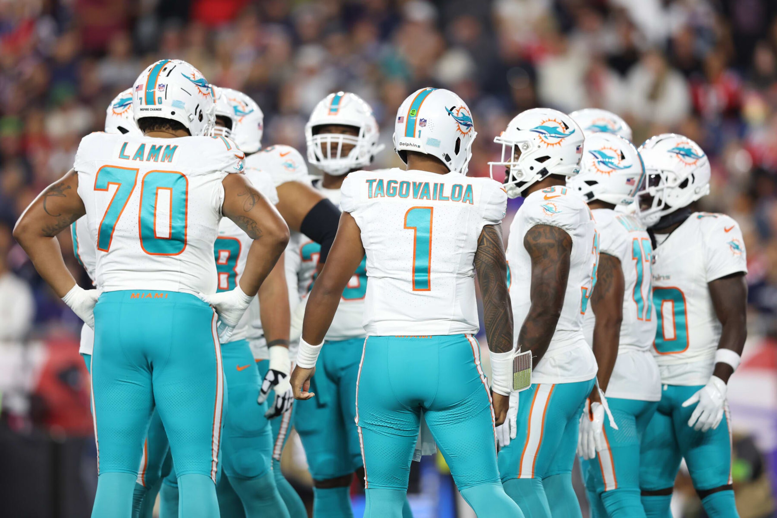 FOXBOROUGH, MASSACHUSETTS - SEPTEMBER 17: Tua Tagovailoa #1 of the Miami Dolphins huddles with the offense during the first quarter against the New England Patriots at Gillette Stadium on September 17, 2023 in Foxborough, Massachusetts. (Photo by Adam Glanzman/Getty Images) FOXBOROUGH, MASSACHUSETTS - SEPTEMBER 17: Tua Tagovailoa #1 of the Miami Dolphins huddles with the offense during the first quarter against the New England Patriots at Gillette Stadium on September 17, 2023 in Foxborough, Massachusetts. (Photo by Adam Glanzman/Getty Images)
