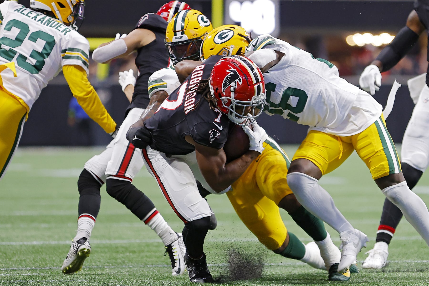 ATLANTA, GEORGIA - SEPTEMBER 17: Bijan Robinson #7 of the Atlanta Falcons is tackled by Quay Walker #7 of the Green Bay Packers during the first quarter at Mercedes-Benz Stadium on September 17, 2023 in Atlanta, Georgia. (Photo by Todd Kirkland/Getty Images)