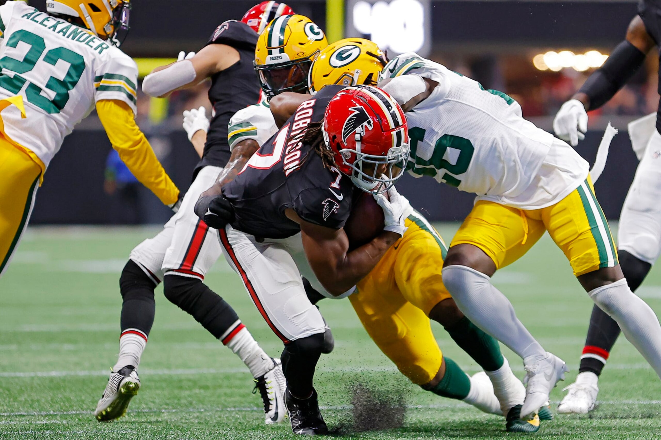 ATLANTA, GEORGIA - SEPTEMBER 17: Bijan Robinson #7 of the Atlanta Falcons is tackled by Quay Walker #7 of the Green Bay Packers during the first quarter at Mercedes-Benz Stadium on September 17, 2023 in Atlanta, Georgia. (Photo by Todd Kirkland/Getty Images)