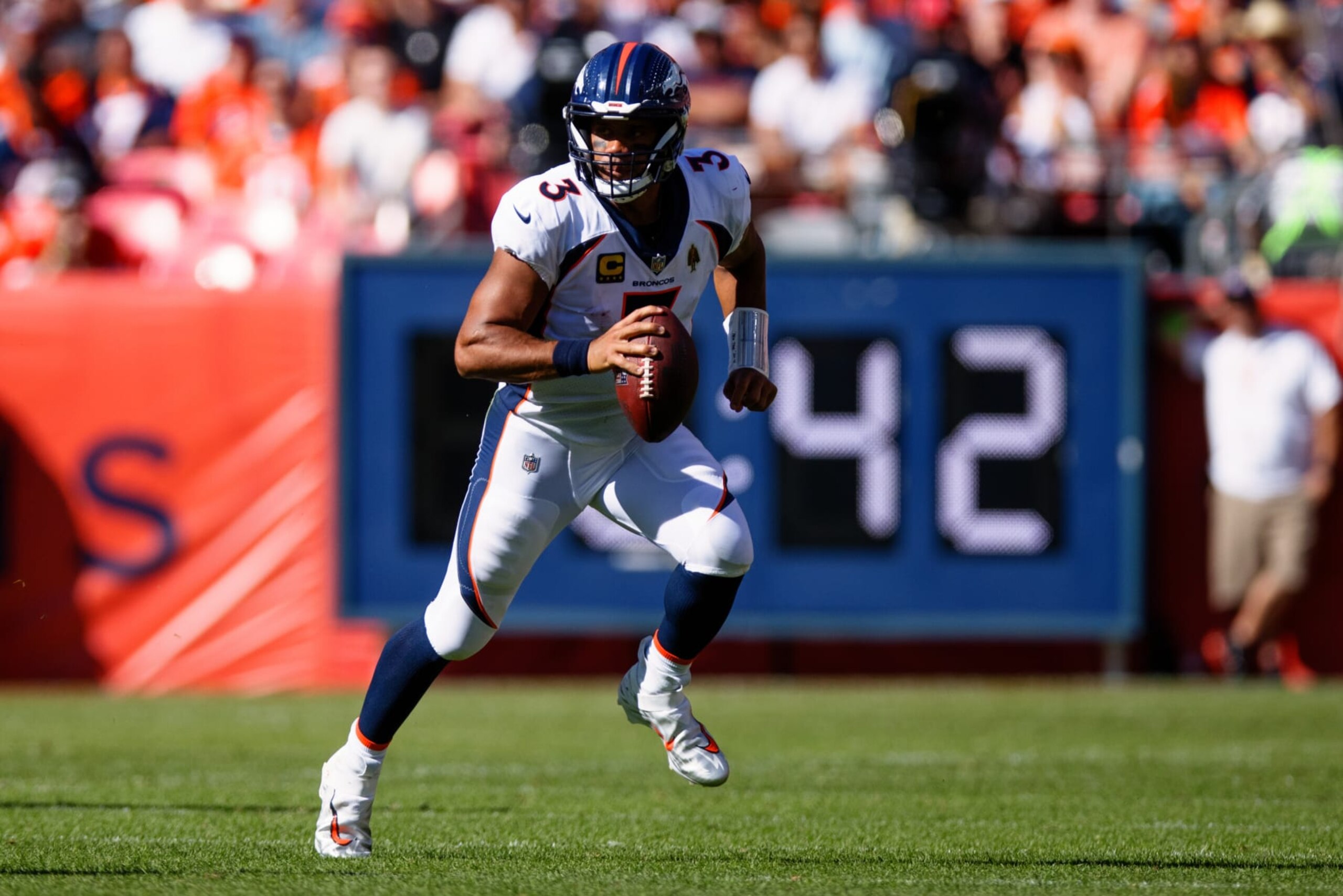 DENVER, CO - SEPTEMBER 17:  Quarterback Russell Wilson #3 of the Denver Broncos runs with the football and looks to pass during the second quarter against the Washington Commanders at Empower Field at Mile High on September 17, 2023 in Denver, Colorado. (Photo by Justin Edmonds/Getty Images)