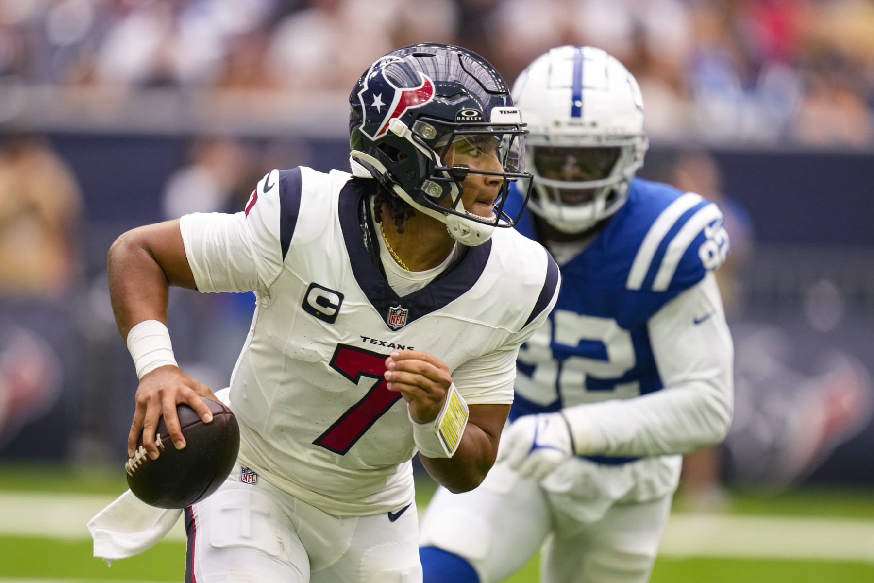 Houston Texans quarterback C.J. Stroud (7) is pursued by Indianapolis Colts defensive end Jake Martin (92) in the first half of an NFL football game in Houston, Sunday, Sept. 17, 2023. (AP Photo/Eric Christian Smith)