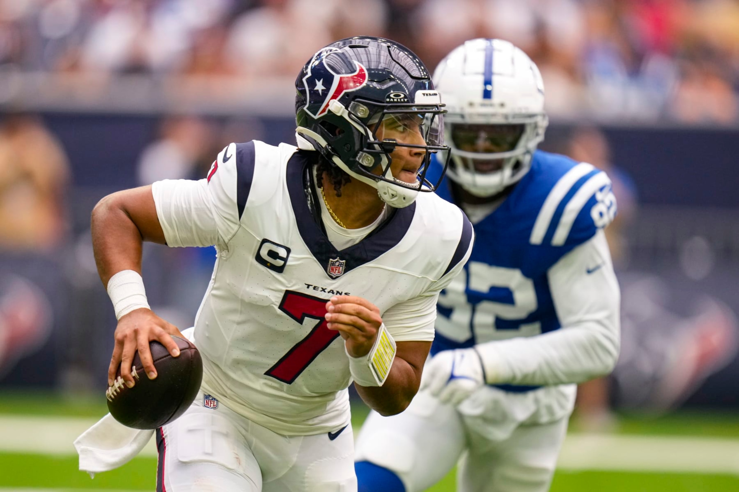 Houston Texans quarterback C.J. Stroud (7) is pursued by Indianapolis Colts defensive end Jake Martin (92) in the first half of an NFL football game in Houston, Sunday, Sept. 17, 2023. (AP Photo/Eric Christian Smith)