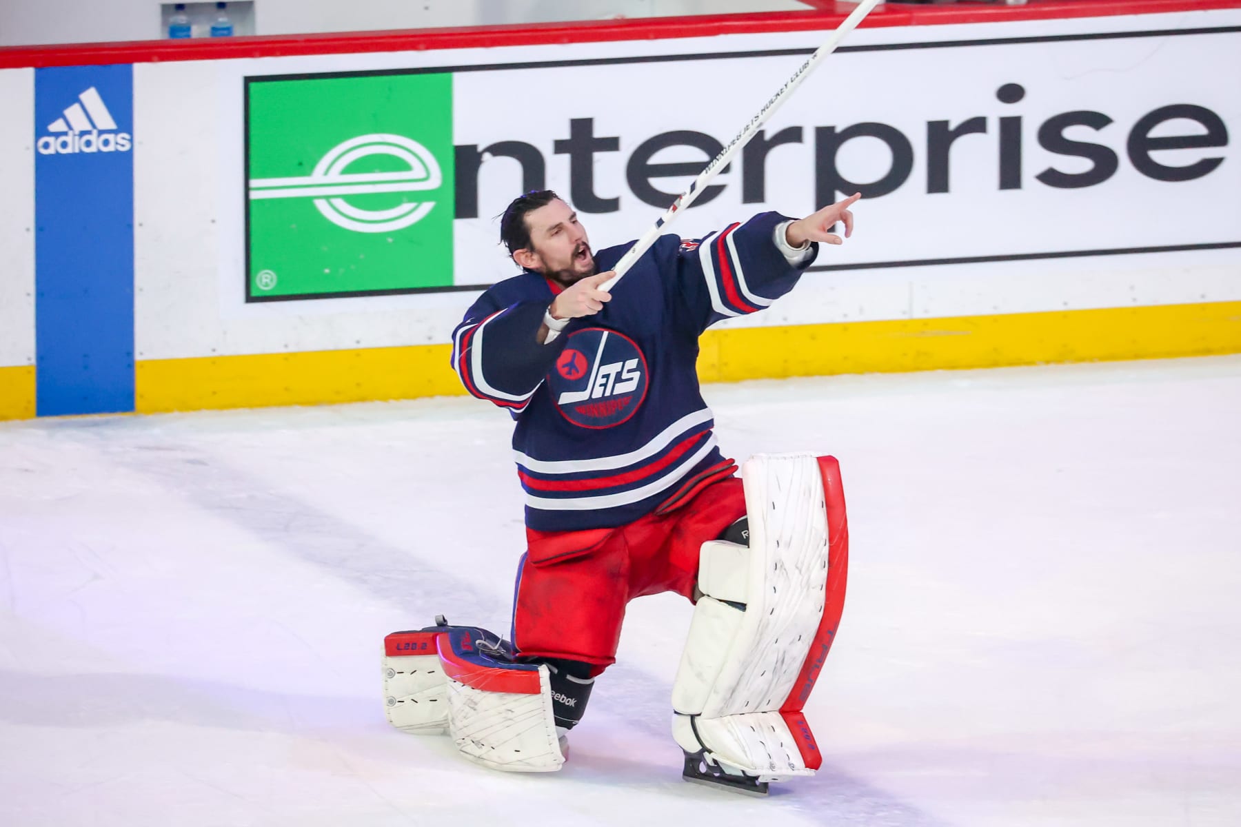 WINNIPEG, CANADA - APRIL 2: Goaltender Connor Hellebuyck #37 of the Winnipeg Jets celebrates on the ice after receiving first star honours following a 6-1 victory over the New Jersey Devils at the Canada Life Centre on April 2, 2023 in Winnipeg, Manitoba, Canada. (Photo by Jonathan Kozub/NHLI via Getty Images)
