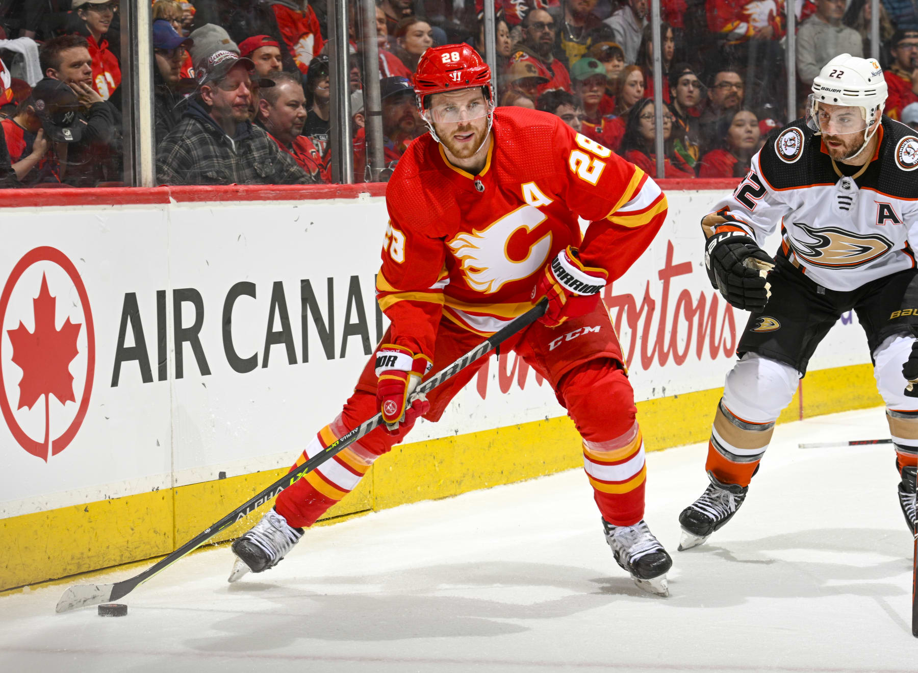 CALGARY, ALBERTA - APRIL 02: Elias Lindholm #28 of the Calgary Flames skates against Kevin Shattenkirk #22 of the Anaheim Ducks at Scotiabank Saddledome on April 02, 2023 in Calgary, Alberta. (Photo by Terence Leung/NHLI via Getty Images)