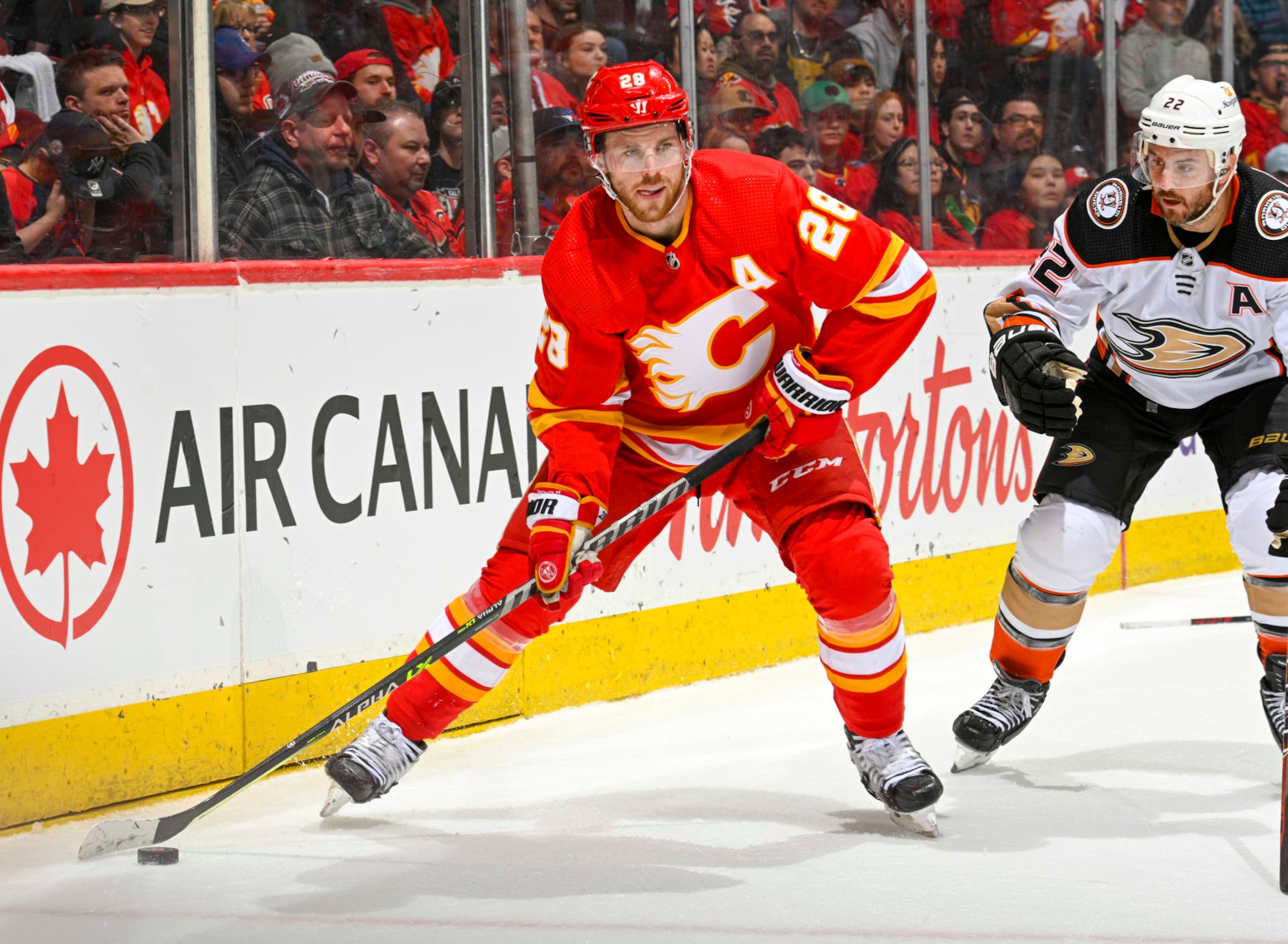 CALGARY, ALBERTA - APRIL 02: Elias Lindholm #28 of the Calgary Flames skates against Kevin Shattenkirk #22 of the Anaheim Ducks at Scotiabank Saddledome on April 02, 2023 in Calgary, Alberta. (Photo by Terence Leung/NHLI via Getty Images)