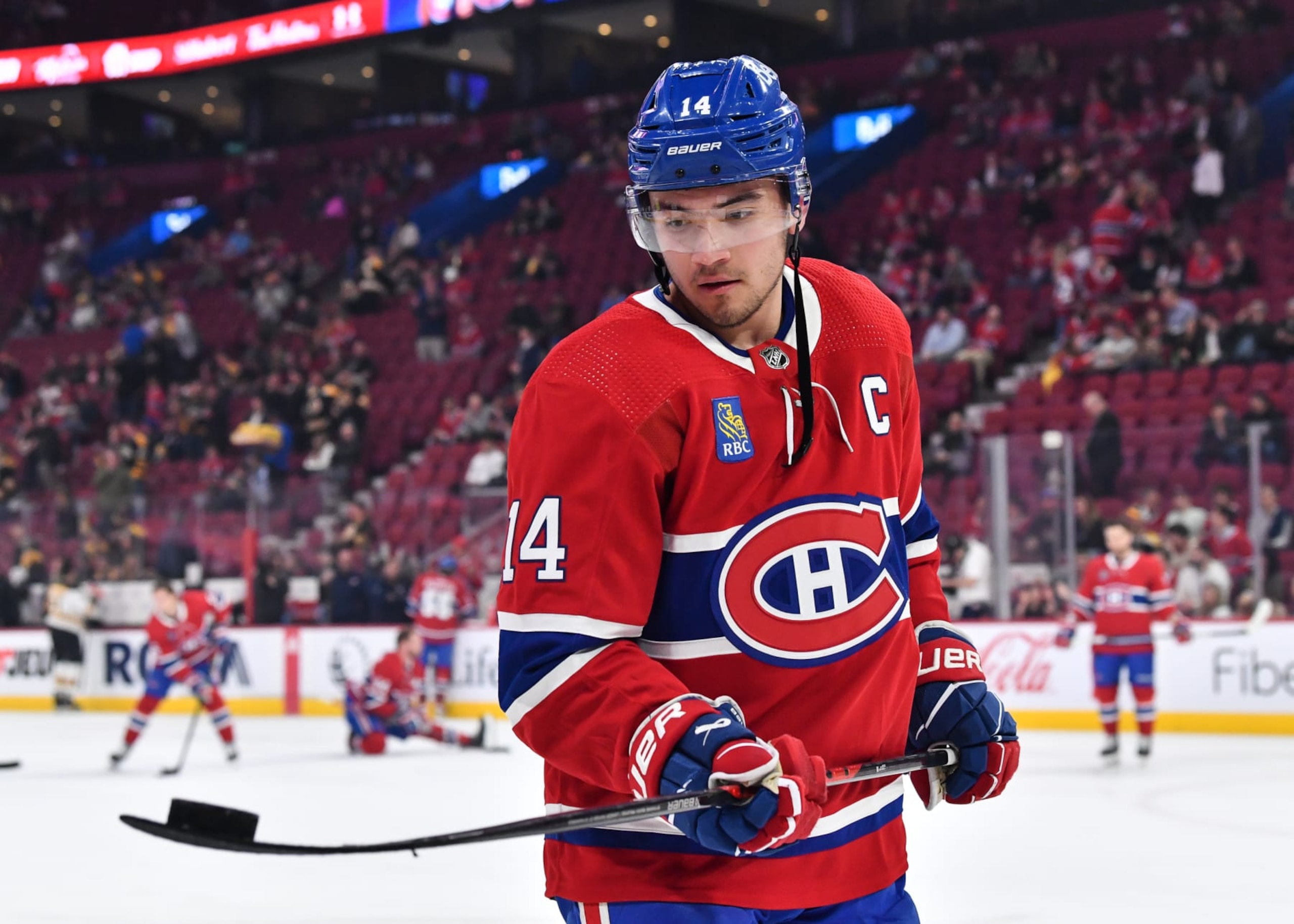 MONTREAL, CANADA - APRIL 13:  Nick Suzuki #14 of the Montreal Canadiens juggles the puck on his stick during warm-ups prior to the game against the Boston Bruins at Centre Bell on April 13, 2023 in Montreal, Quebec, Canada.  The Boston Bruins defeated the Montreal Canadiens 5-4.  (Photo by Minas Panagiotakis/Getty Images)