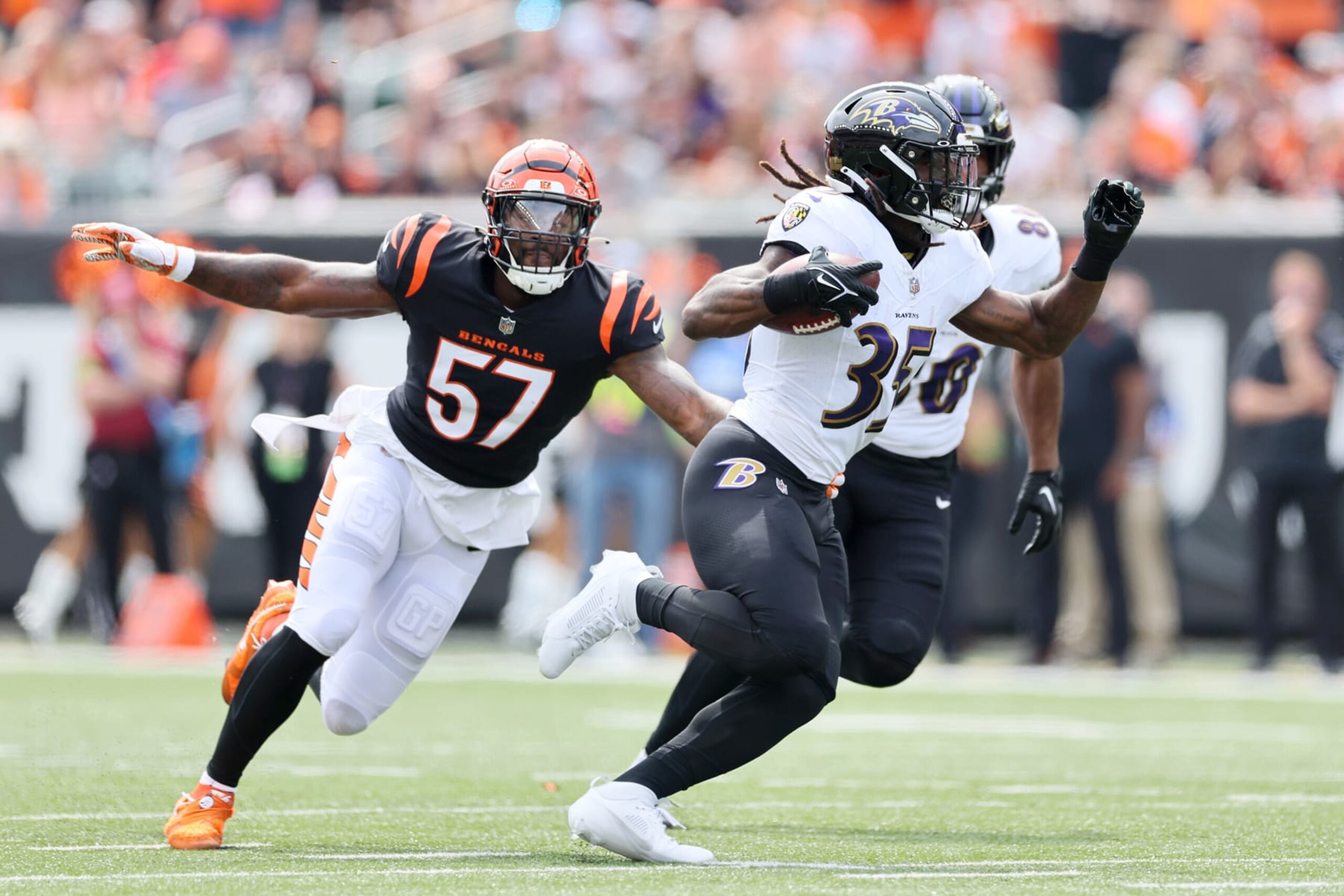 CINCINNATI, OHIO - SEPTEMBER 17: Gus Edwards #35 of the Baltimore Ravens runs the ball while defended by Germaine Pratt #57 of the Cincinnati Bengals during the first quarter at Paycor Stadium on September 17, 2023 in Cincinnati, Ohio. (Photo by Andy Lyons/Getty Images)