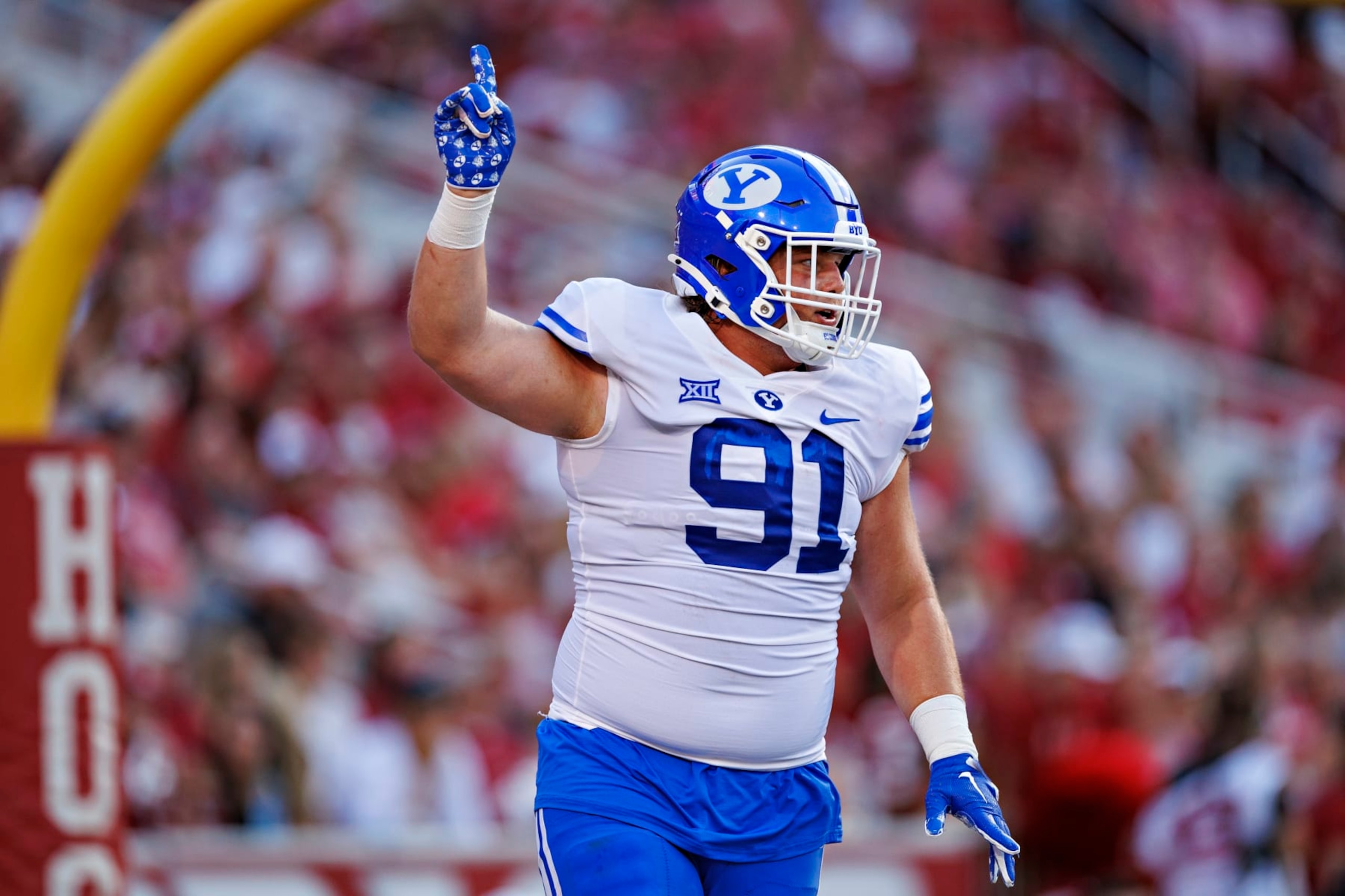 FAYETTEVILLE, ARKANSAS - SEPTEMBER 16: Jackson Cravens #91 of the BYU Cougars celebrates after his team scored a touchdown in the first half of the game against the Arkansas Razorbacks at Donald W. Reynolds Razorback Stadium on September 16, 2023 in Fayetteville, Arkansas. (Photo by Wesley Hitt/Getty Images)