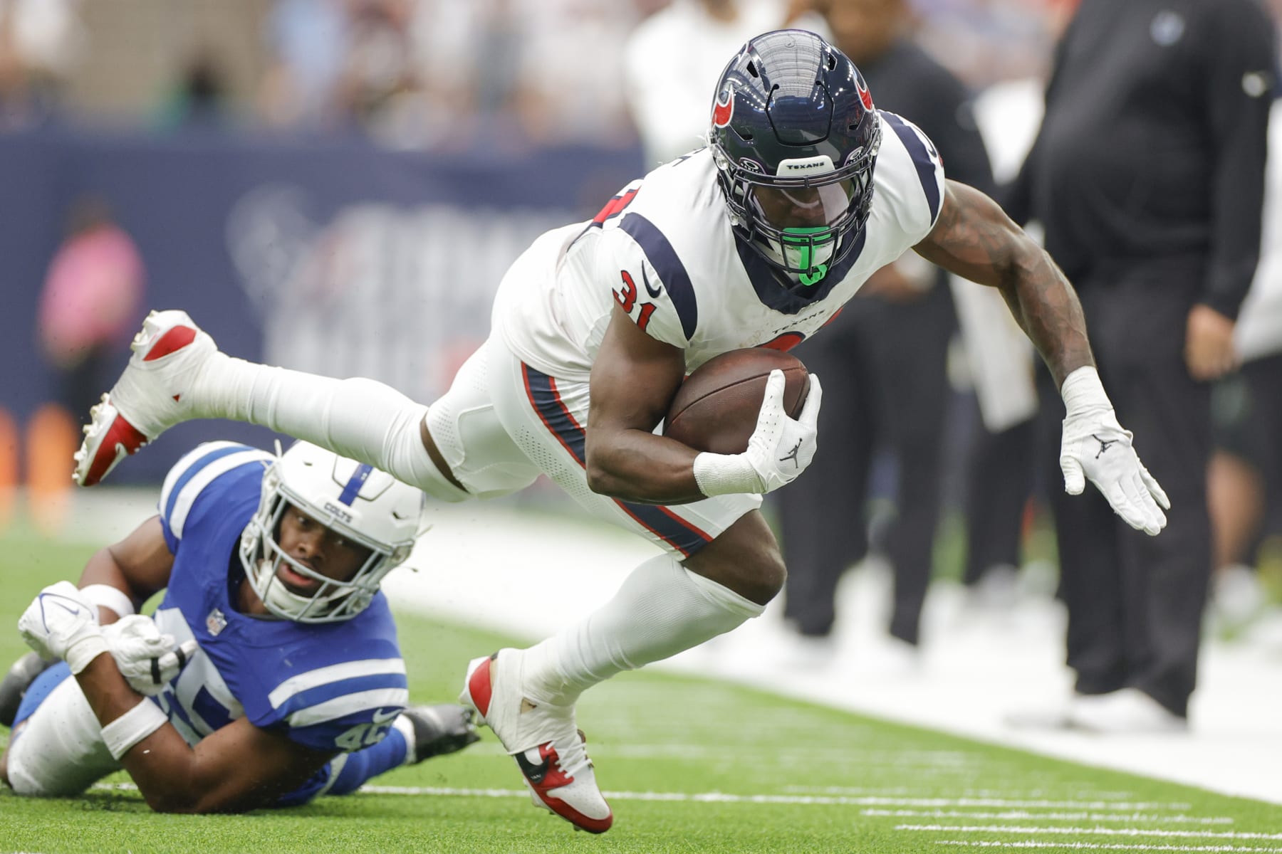HOUSTON, TEXAS - SEPTEMBER 17: Dameon Pierce #31 of the Houston Texans is tackled by E.J. Speed #45 of the Indianapolis Colts during the first quarter at NRG Stadium on September 17, 2023 in Houston, Texas. (Photo by Carmen Mandato/Getty Images)