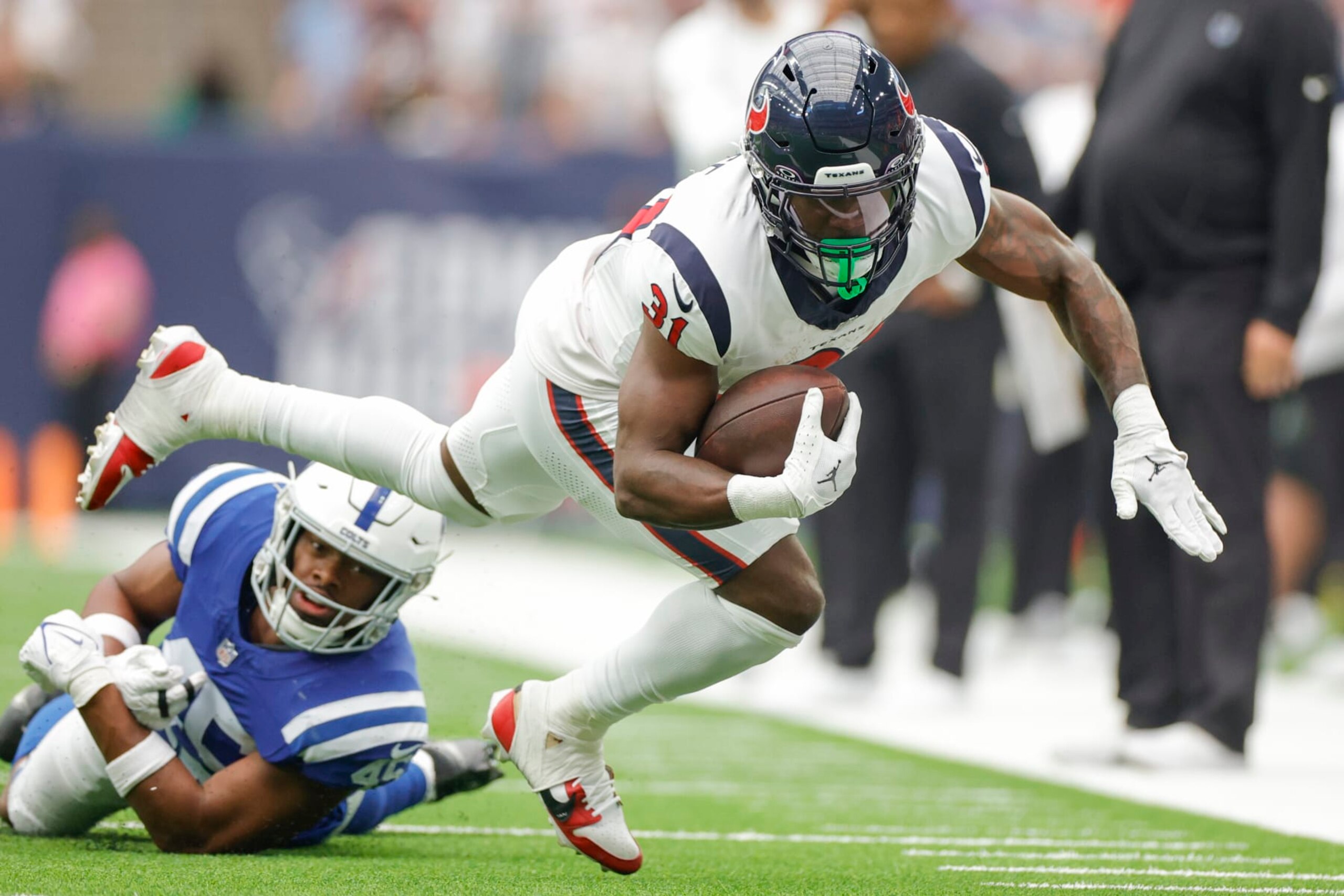 HOUSTON, TEXAS - SEPTEMBER 17: Dameon Pierce #31 of the Houston Texans is tackled by E.J. Speed #45 of the Indianapolis Colts during the first quarter at NRG Stadium on September 17, 2023 in Houston, Texas. (Photo by Carmen Mandato/Getty Images)