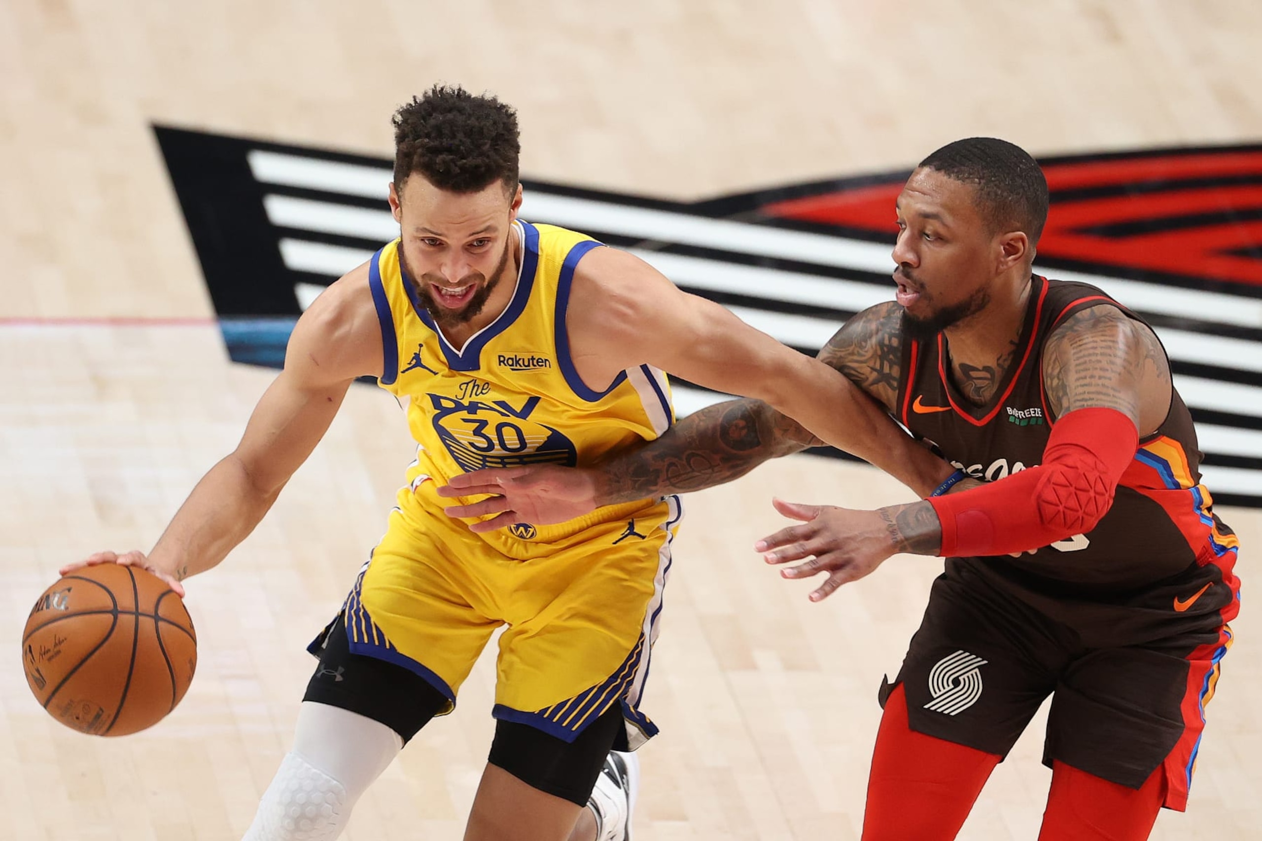 PORTLAND, OREGON - MARCH 03: Stephen Curry #30 of the Golden State Warriors dribbles against Damian Lillard #0 of the Portland Trail Blazers in the first quarter at Moda Center on March 03, 2021 in Portland, Oregon. NOTE TO USER: User expressly acknowledges and agrees that, by downloading and or using this photograph, User is consenting to the terms and conditions of the Getty Images License Agreement. (Photo by Abbie Parr/Getty Images) PORTLAND, OREGON - MARCH 03: Stephen Curry #30 of the Golden State Warriors dribbles against Damian Lillard #0 of the Portland Trail Blazers in the first quarter at Moda Center on March 03, 2021 in Portland, Oregon. NOTE TO USER: User expressly acknowledges and agrees that, by downloading and or using this photograph, User is consenting to the terms and conditions of the Getty Images License Agreement. (Photo by Abbie Parr/Getty Images)