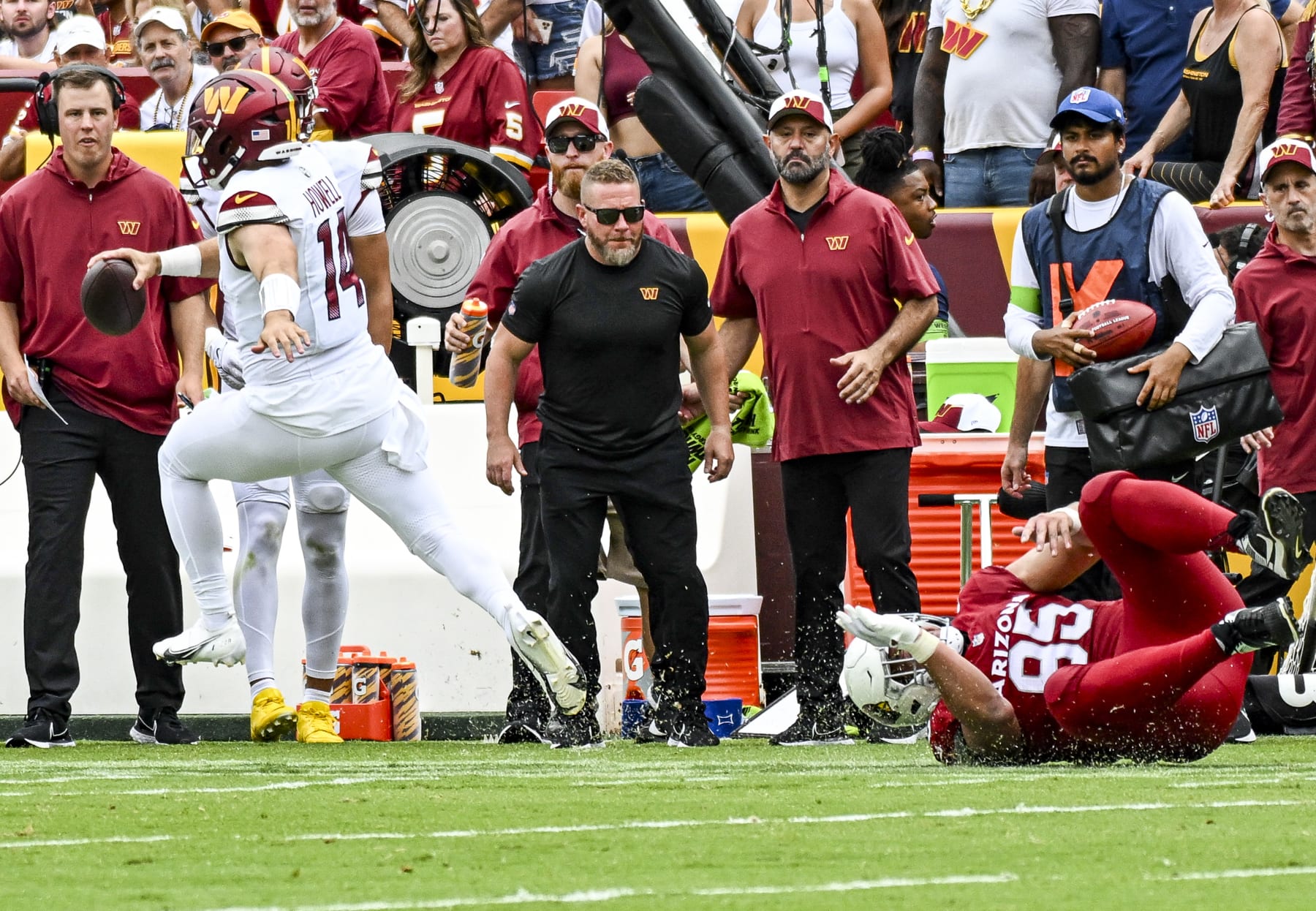 LANDOVER, MD - SEPTEMBER 10: Washington Commanders quarterback Sam Howell (14) scrambles avoiding the tackle of Arizona Cardinals defensive tackle Leki Fotu (95) during the NFL game between the Arizona Cardinals and the Washington Commanders on September 10, 2023 at Fed Ex Field in Landover, MD. (Photo by Mark Goldman/Icon Sportswire via Getty Images)