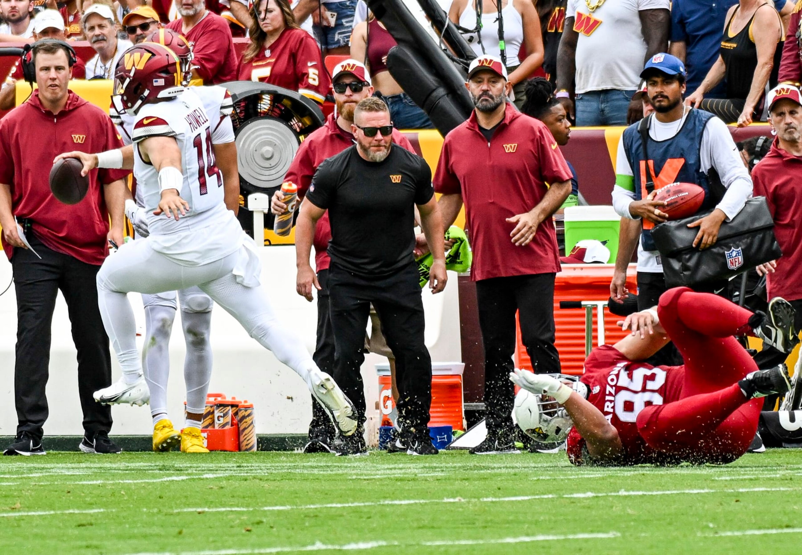 LANDOVER, MD - SEPTEMBER 10: Washington Commanders quarterback Sam Howell (14) scrambles avoiding the tackle of Arizona Cardinals defensive tackle Leki Fotu (95) during the NFL game between the Arizona Cardinals and the Washington Commanders on September 10, 2023 at Fed Ex Field in Landover, MD. (Photo by Mark Goldman/Icon Sportswire via Getty Images)
