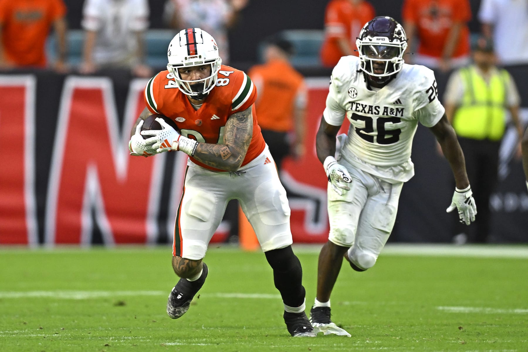 MIAMI GARDENS, FL - SEPTEMBER 09:  Miami tight end Cam McCormick (84) takes a reception 20 yards while pursued by Texas A&M defensive back Demani Richardson (26) in the fourth quarter as the Miami Hurricanes faced the Texas A&M Aggies on September 9, 2023, at Hard Rock Stadium in Miami Gardens, Florida. (Photo by Samuel Lewis/Icon Sportswire via Getty Images)
