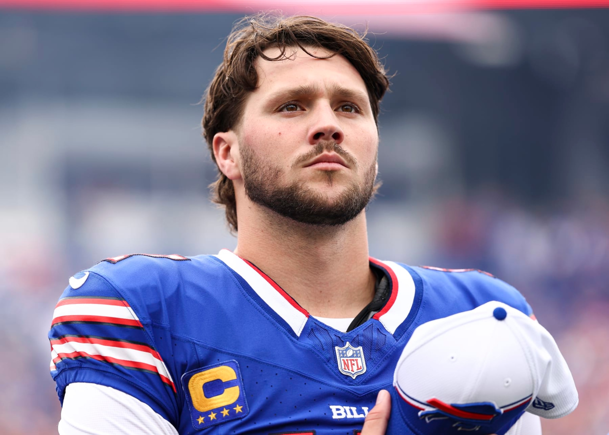 ORCHARD PARK, NY - SEPTEMBER 17: Josh Allen #17 of the Buffalo Bills stands on the sidelines during the national anthem prior to an NFL football game against the Las Vegas Raiders at Highmark Stadium on September 17, 2023 in Orchard Park, New York. (Photo by Kevin Sabitus/Getty Images) ORCHARD PARK, NY - SEPTEMBER 17: Josh Allen #17 of the Buffalo Bills stands on the sidelines during the national anthem prior to an NFL football game against the Las Vegas Raiders at Highmark Stadium on September 17, 2023 in Orchard Park, New York. (Photo by Kevin Sabitus/Getty Images)
