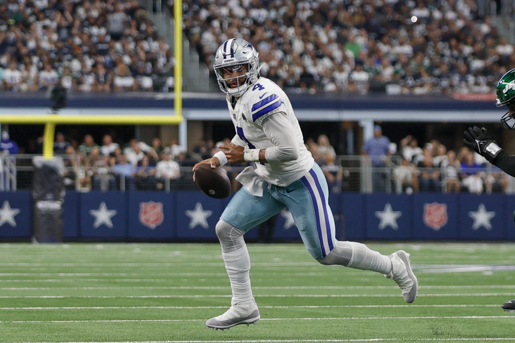 ARLINGTON, TX - SEPTEMBER 17: Dallas Cowboys quarterback Dak Prescott (4) scrambles out of the pocket looking for a wide receiver during the game between the Dallas Cowboys and the New York Jets on September 17, 2023 at AT&T Stadium in Arlington, Texas. (Photo by Matthew Pearce/Icon Sportswire via Getty Images)