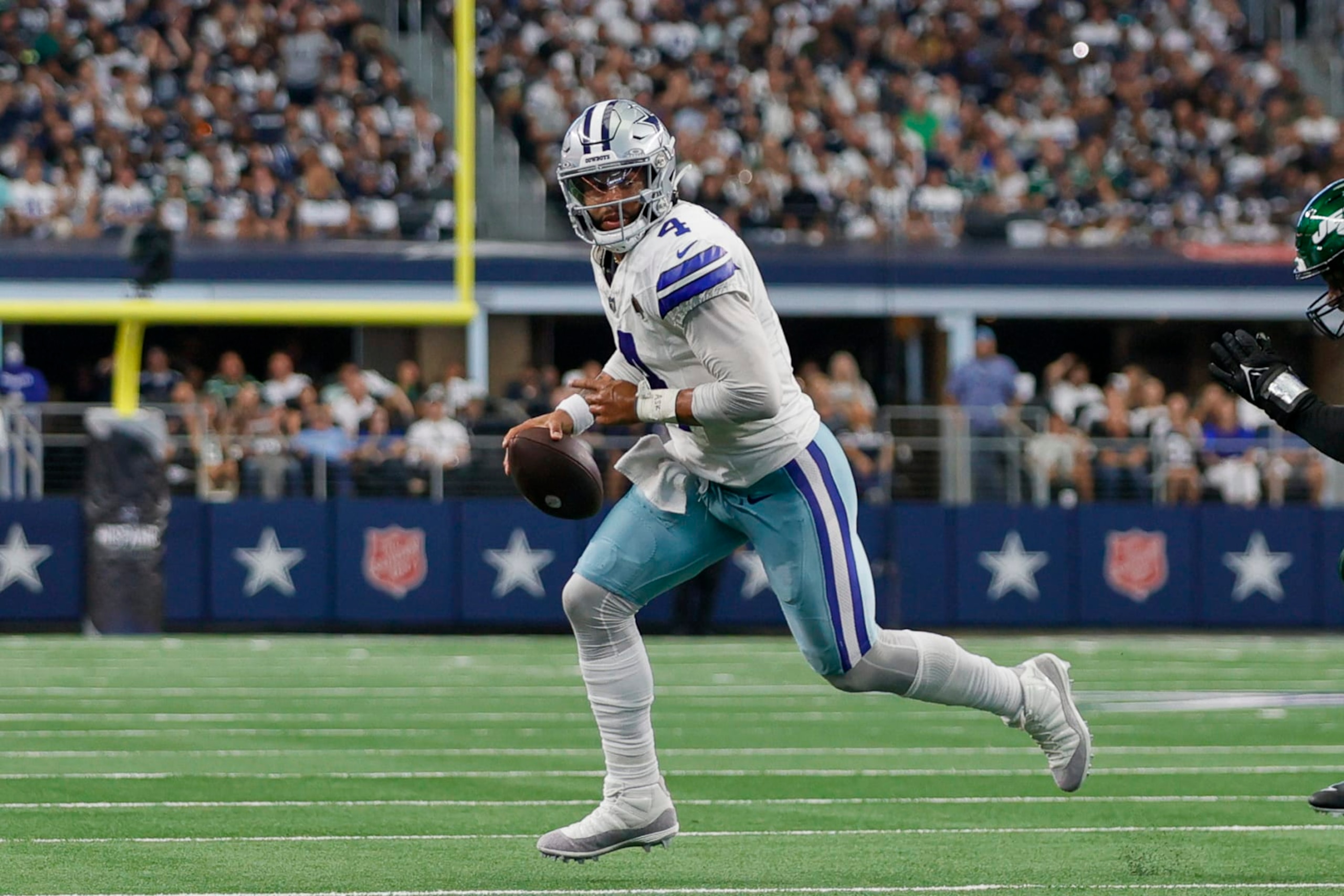 ARLINGTON, TX - SEPTEMBER 17: Dallas Cowboys quarterback Dak Prescott (4) scrambles out of the pocket looking for a wide receiver during the game between the Dallas Cowboys and the New York Jets on September 17, 2023 at AT&T Stadium in Arlington, Texas. (Photo by Matthew Pearce/Icon Sportswire via Getty Images) ARLINGTON, TX - SEPTEMBER 17: Dallas Cowboys quarterback Dak Prescott (4) scrambles out of the pocket looking for a wide receiver during the game between the Dallas Cowboys and the New York Jets on September 17, 2023 at AT&T Stadium in Arlington, Texas. (Photo by Matthew Pearce/Icon Sportswire via Getty Images)