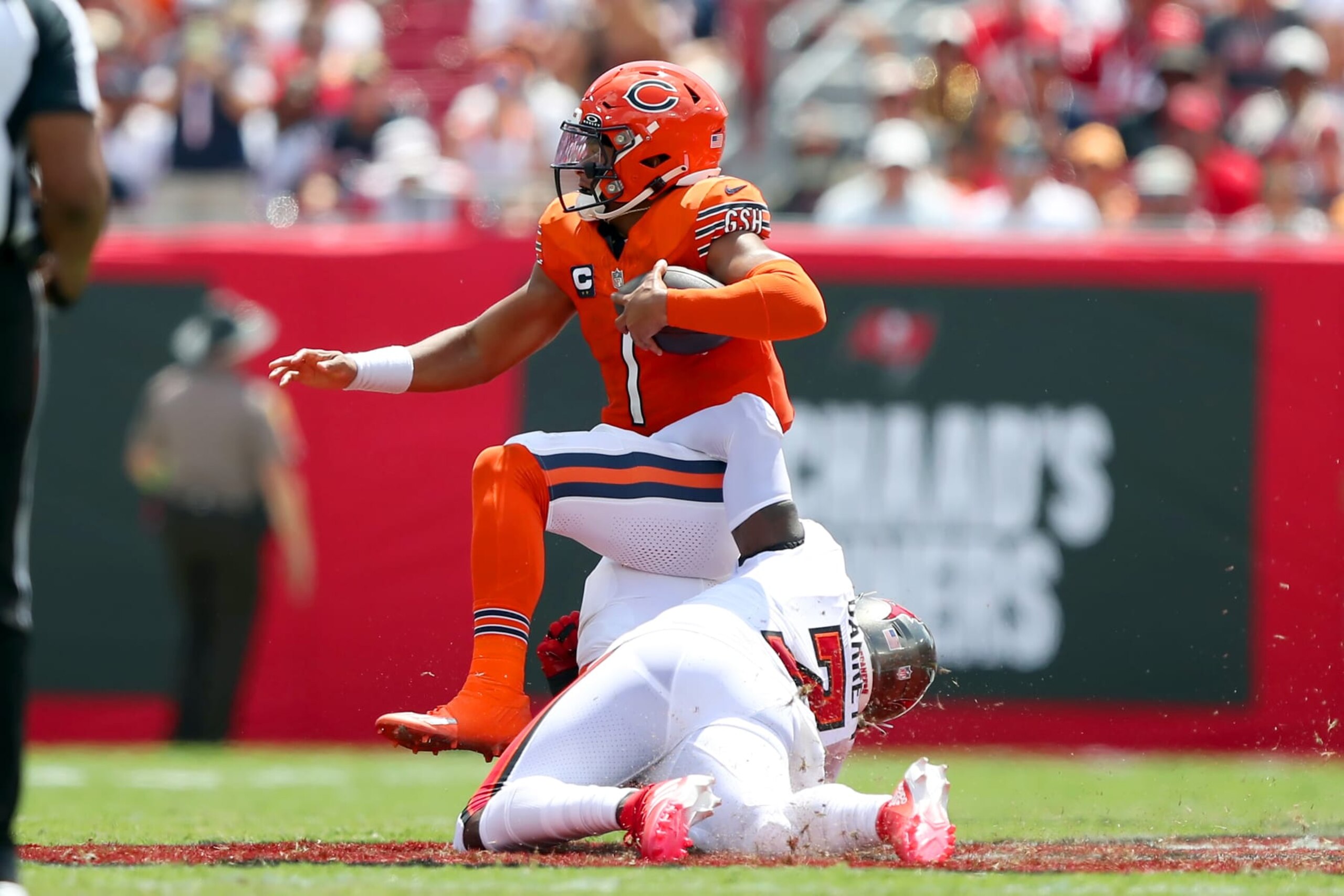 TAMPA, FL - SEPTEMBER 17: Chicago Bears Quarterback Justin Fields (1) is dragged down by Tampa Bay Buccaneers Linebacker Shaq Barrett (7) during the regular season game between the Chicago Bears and the Tampa Bay Buccaneers on September 17, 2023 at Raymond James Stadium in Tampa, Florida. (Photo by Cliff Welch/Icon Sportswire via Getty Images)