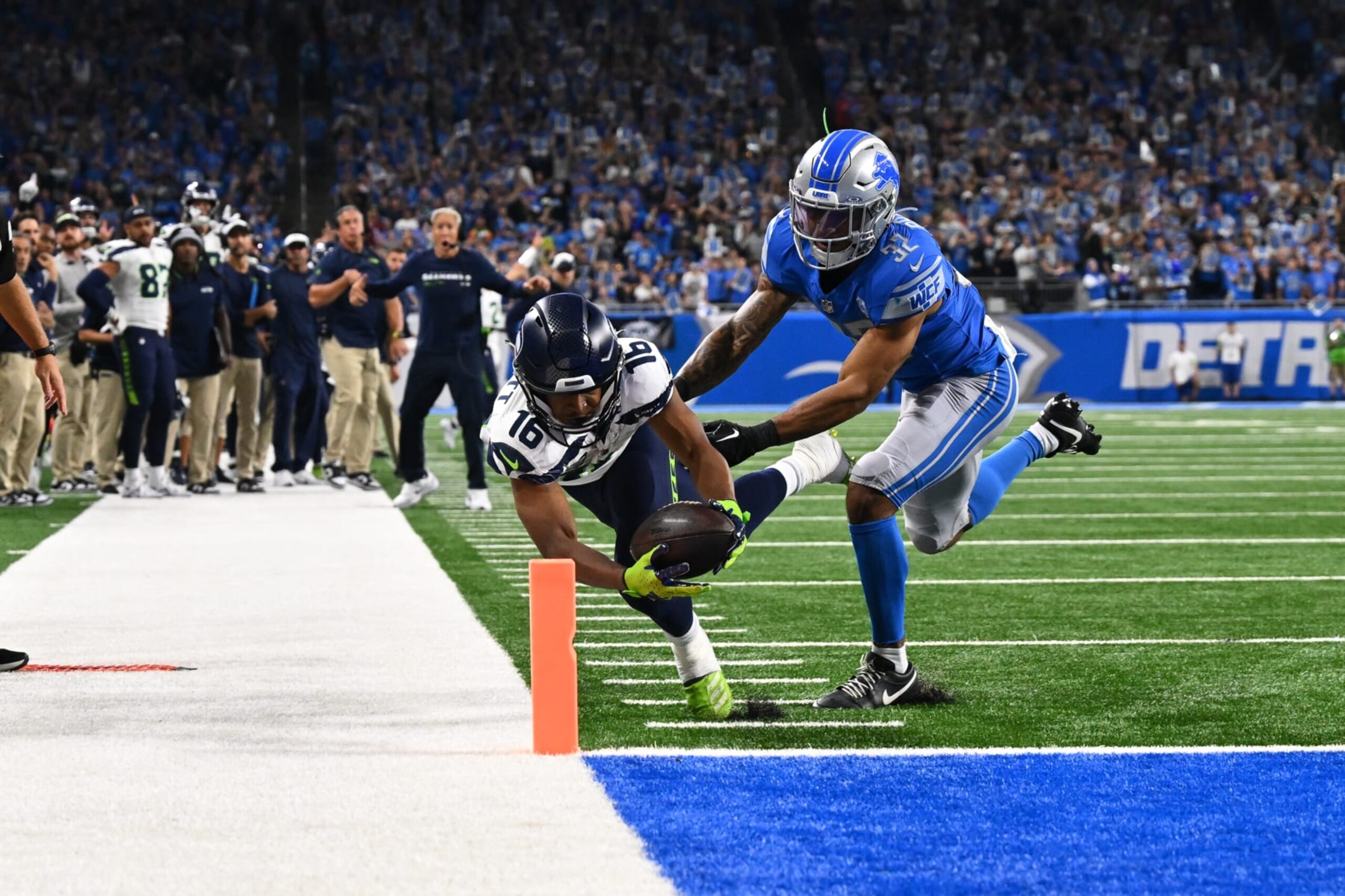 DETROIT, MI - SEPTEMBER 17: Seattle Seahawks wide receiver Tyler Lockett (16) reaches out for the pylon as Detroit Lions safety Brian Branch (32) tries in vain to push him out of bounds during the Detroit Lions versus the Seattle Seahawks game on Sunday September 17, 2023 at Ford Field in Detroit, MI. (Photo by Steven King/Icon Sportswire via Getty Images)