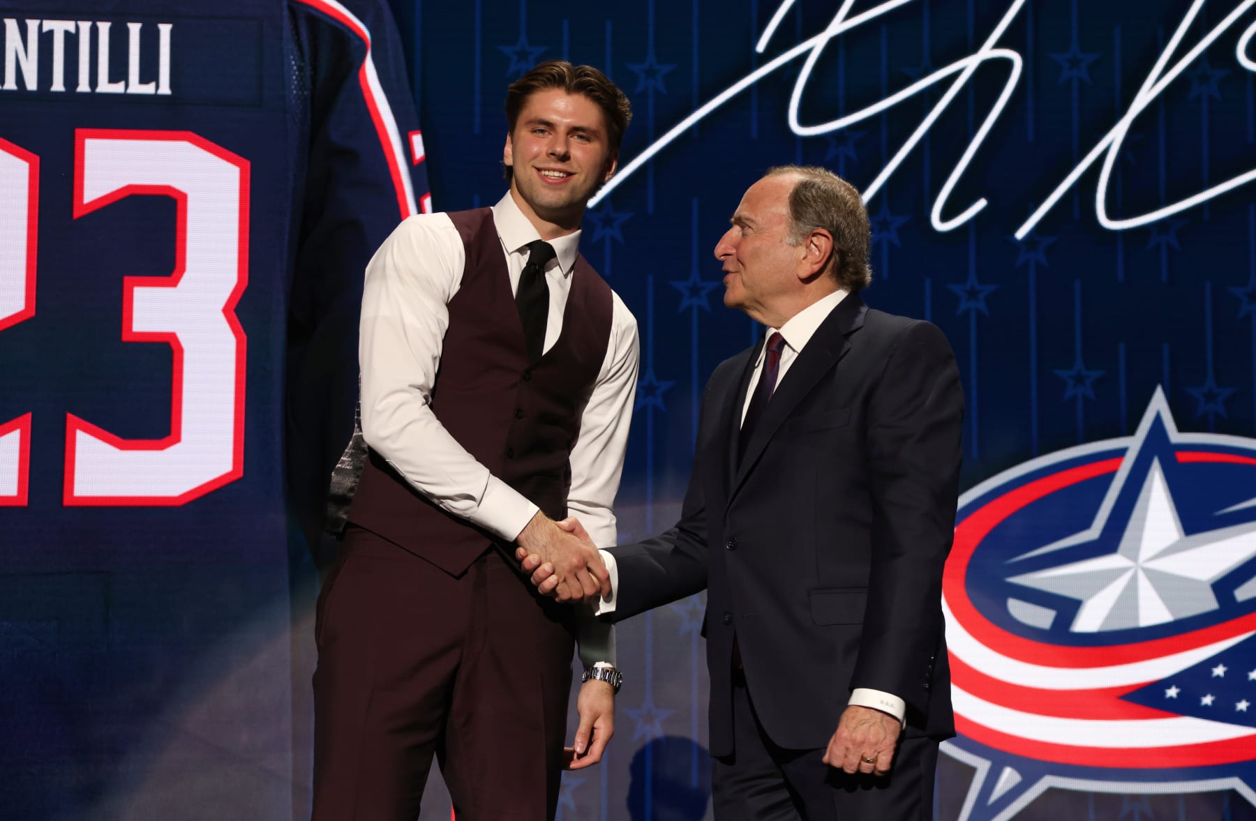 Adam Fantilli (left) and NHL Commissioner Gary Bettman