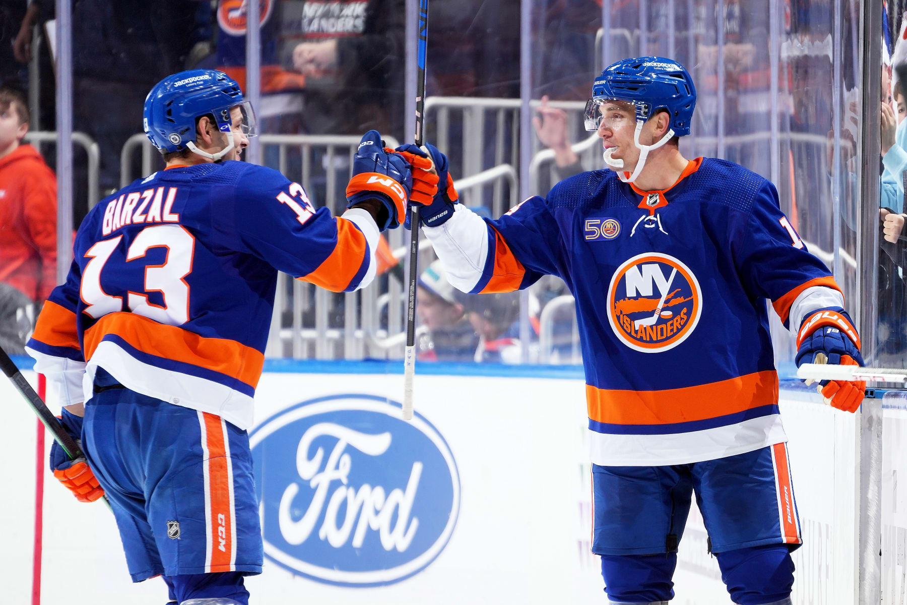ELMONT, NEW YORK - FEBRUARY 07:  Bo Horvat #14 of the New York Islanders is congratulated by his teammate Mathew Barzal #13 after scoring a goal against the Seattle Kraken dsecond period at UBS Arena on February 07, 2023 in Elmont, New York. (Photo by Mike Stobe/NHLI via Getty Images)