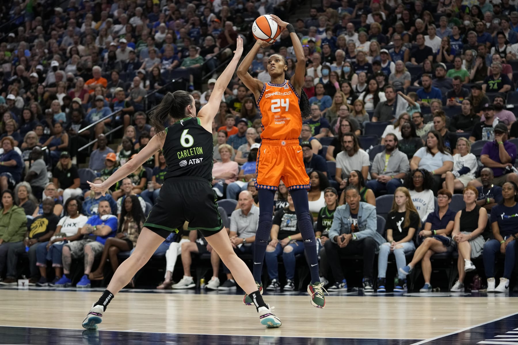 Connecticut Sun forward DeWanna Bonner (24) shoots over Minnesota Lynx forward Bridget Carleton (6) during the first half of Game 3 of a WNBA first-round basketball playoff series Wednesday, Sept. 20, 2023, in Minneapolis. (AP Photo/Abbie Parr)