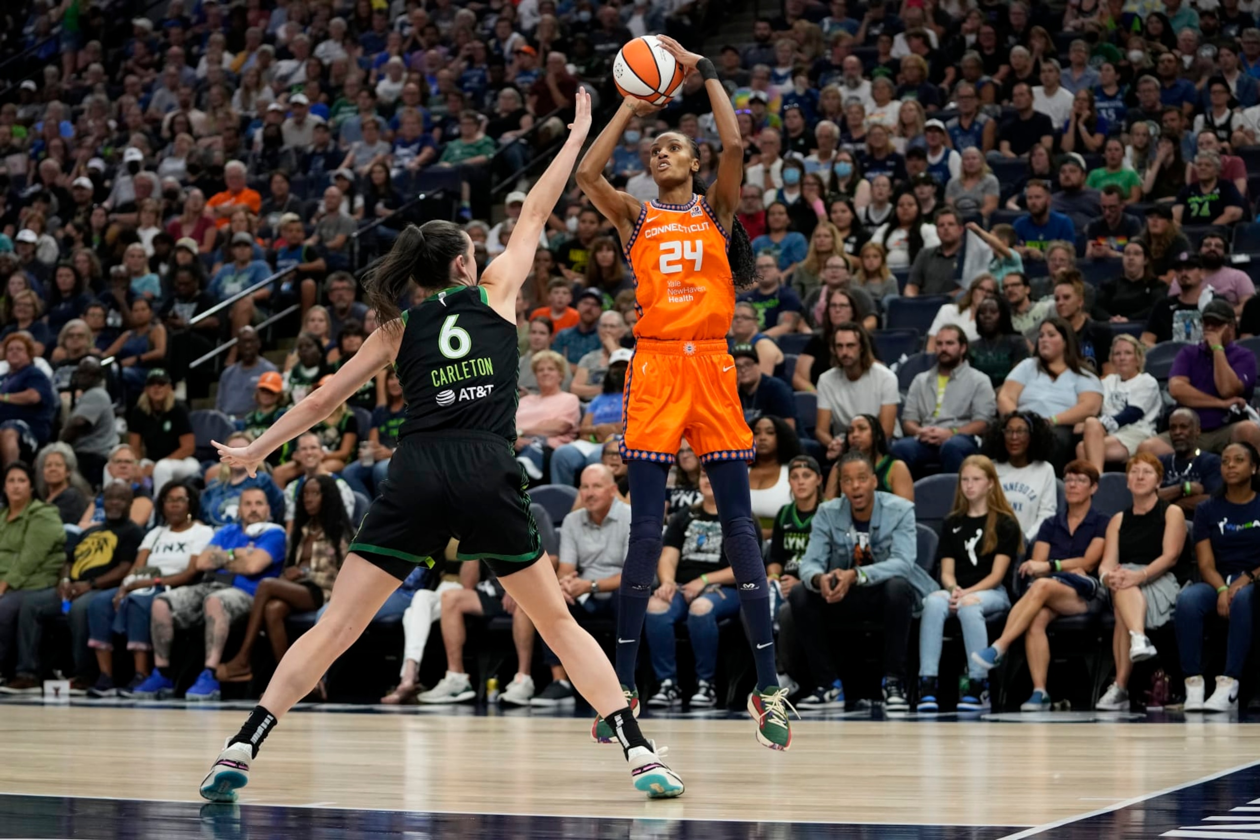 Connecticut Sun forward DeWanna Bonner (24) shoots over Minnesota Lynx forward Bridget Carleton (6) during the first half of Game 3 of a WNBA first-round basketball playoff series Wednesday, Sept. 20, 2023, in Minneapolis. (AP Photo/Abbie Parr)