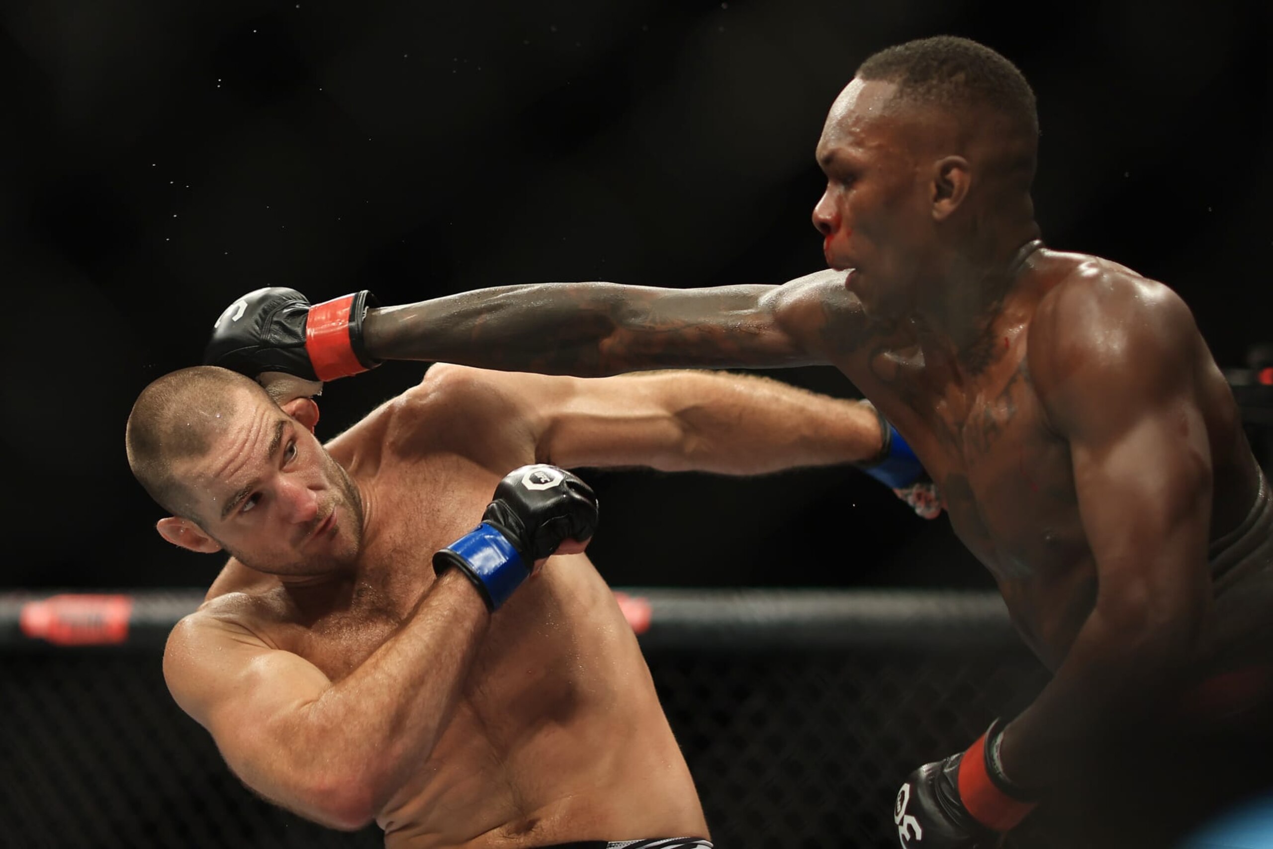 SYDNEY, AUSTRALIA - SEPTEMBER 10: Sean Strickland of United States trades punches with Israel Adesanya of Nigeria during the UFC 293 event at Qudos Bank Arena on September 10, 2023 in Sydney, Australia. (Photo by Mark Evans/Getty Images) SYDNEY, AUSTRALIA - SEPTEMBER 10: Sean Strickland of United States trades punches with Israel Adesanya of Nigeria during the UFC 293 event at Qudos Bank Arena on September 10, 2023 in Sydney, Australia. (Photo by Mark Evans/Getty Images)