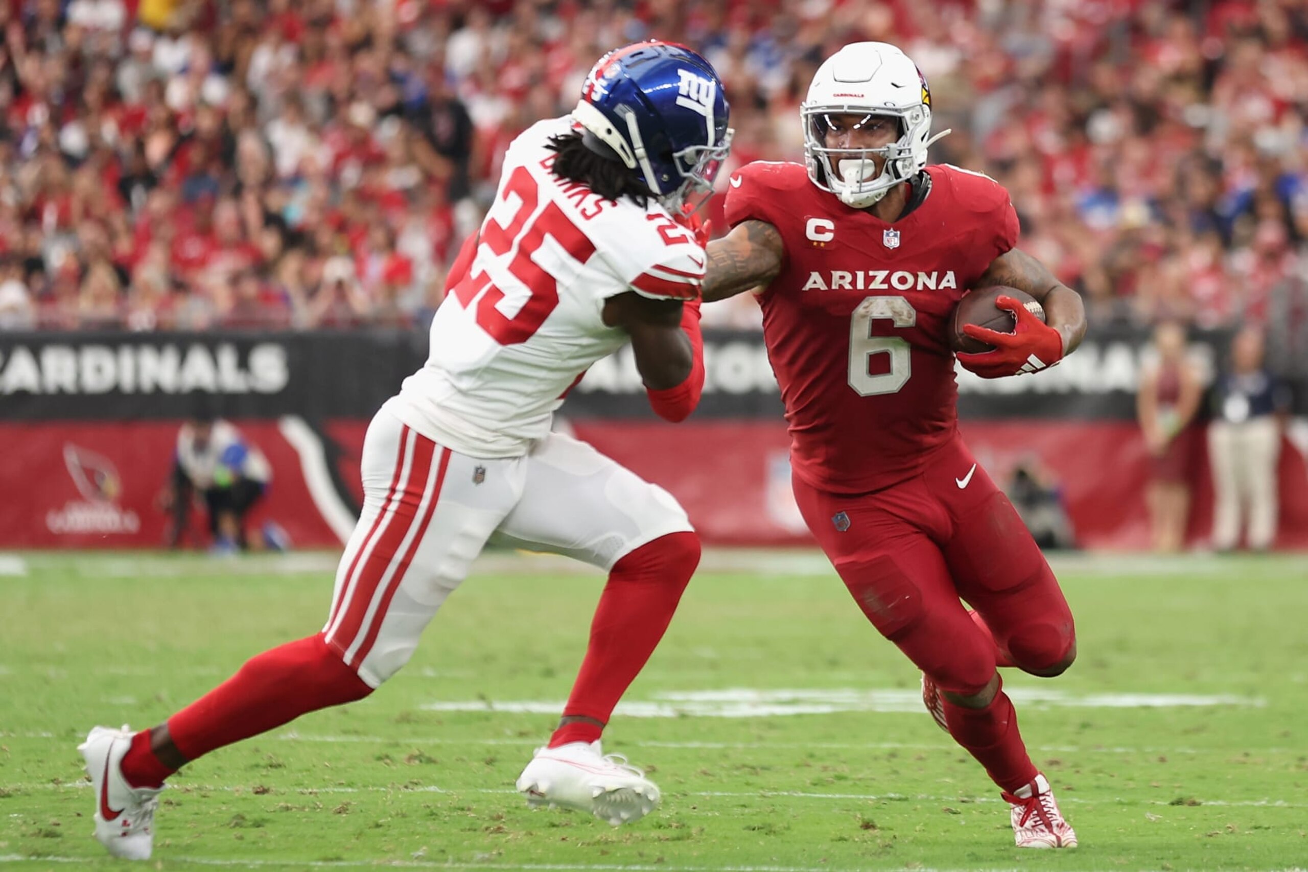 GLENDALE, ARIZONA - SEPTEMBER 17: Running back James Conner #6 of the Arizona Cardinals rushes the football against cornerback Deonte Banks #25 of the New York Giants during the NFL game at State Farm Stadium on September 17, 2023 in Glendale, Arizona. The Giants defeated the Cardinals 31-28.  (Photo by Christian Petersen/Getty Images)