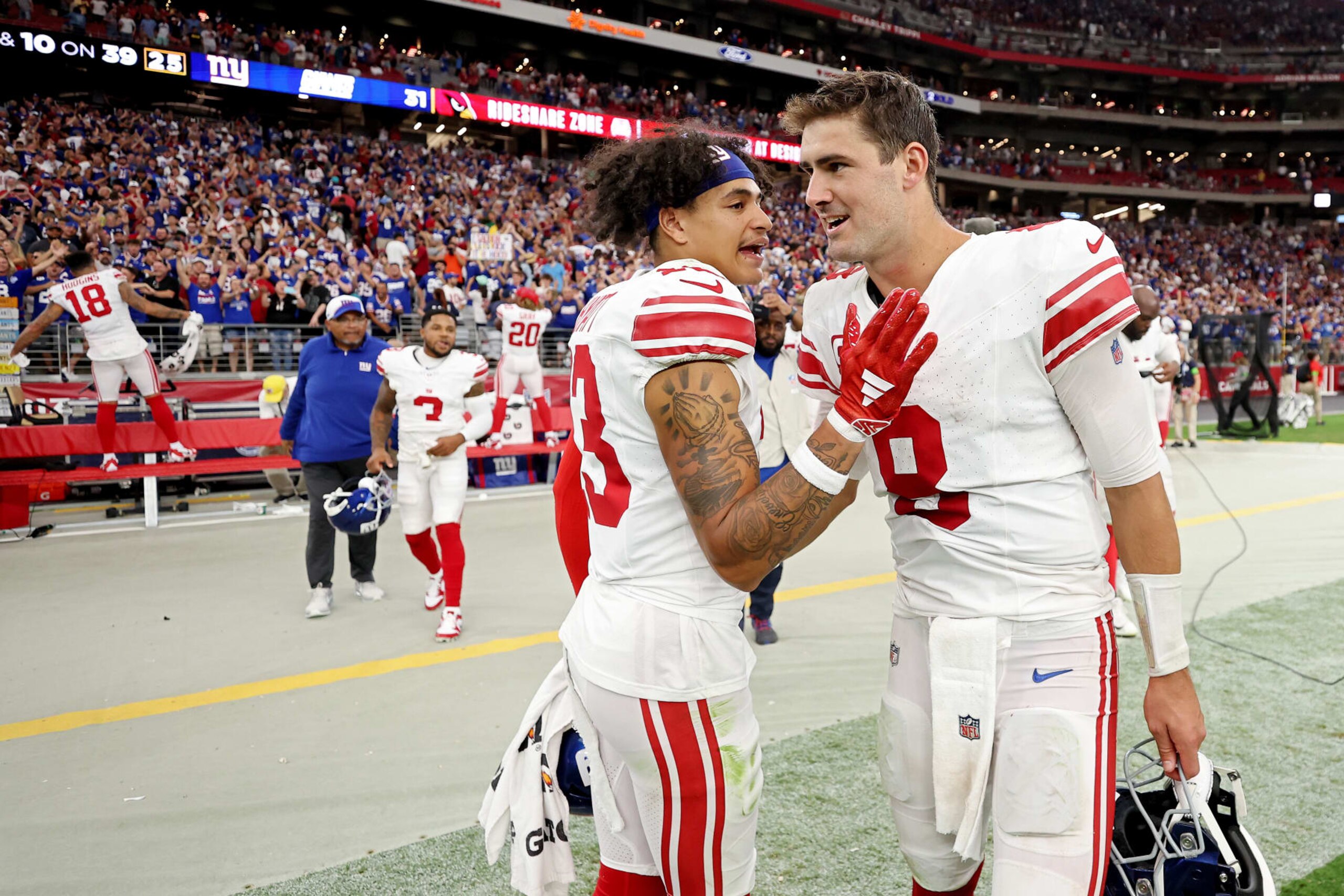 GLENDALE, ARIZONA - SEPTEMBER 17: Jalin Hyatt #13 of the New York Giants celebrates with Daniel Jones #8 after a win over the Arizona Cardinals at State Farm Stadium on September 17, 2023 in Glendale, Arizona. (Photo by Christian Petersen/Getty Images)
