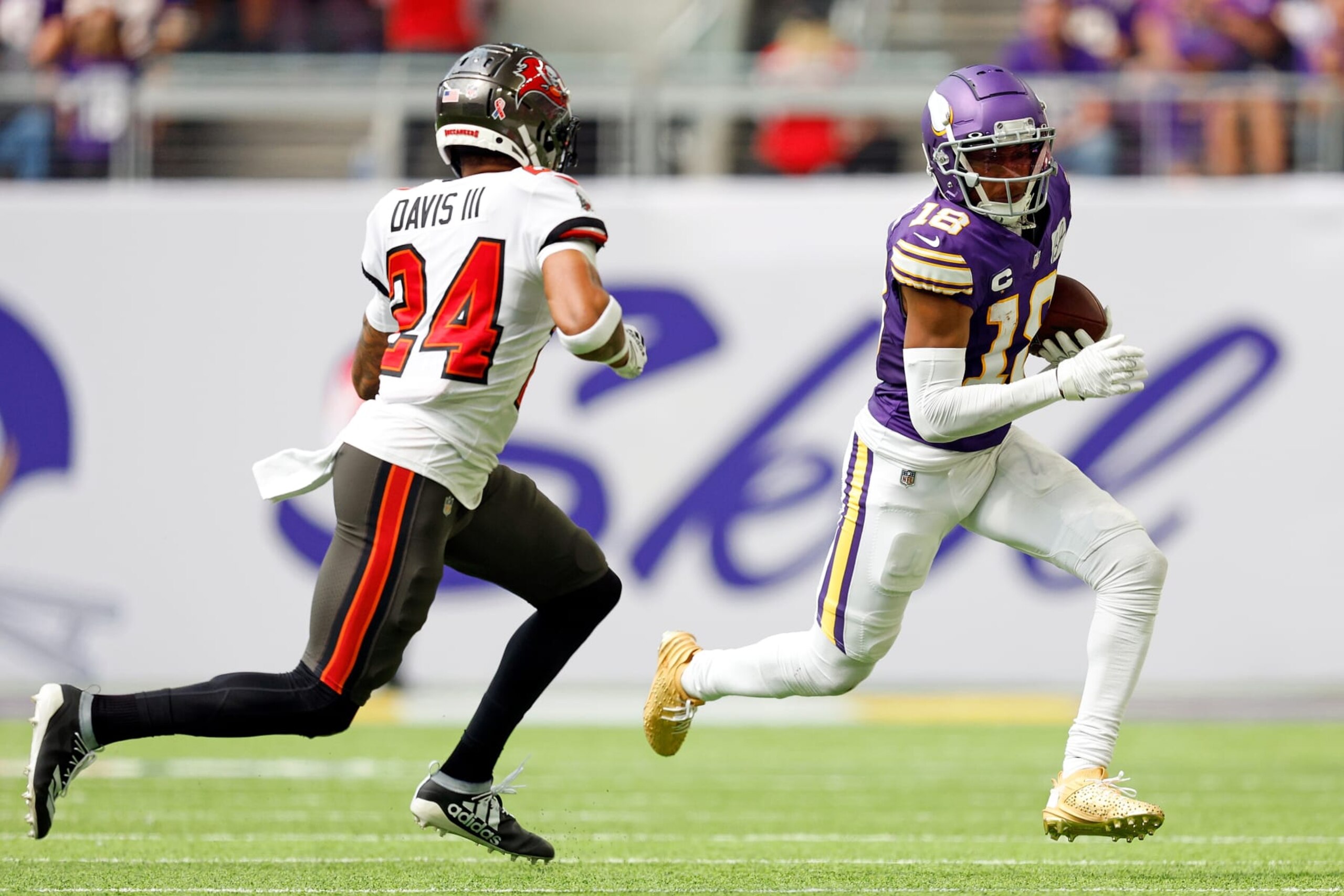 MINNEAPOLIS, MINNESOTA - SEPTEMBER 10: Justin Jefferson #18 of the Minnesota Vikings runs with the ball while Carlton Davis III #24 of the Tampa Bay Buccaneers defends in the first half at U.S. Bank Stadium on September 10, 2023 in Minneapolis, Minnesota. (Photo by David Berding/Getty Images)