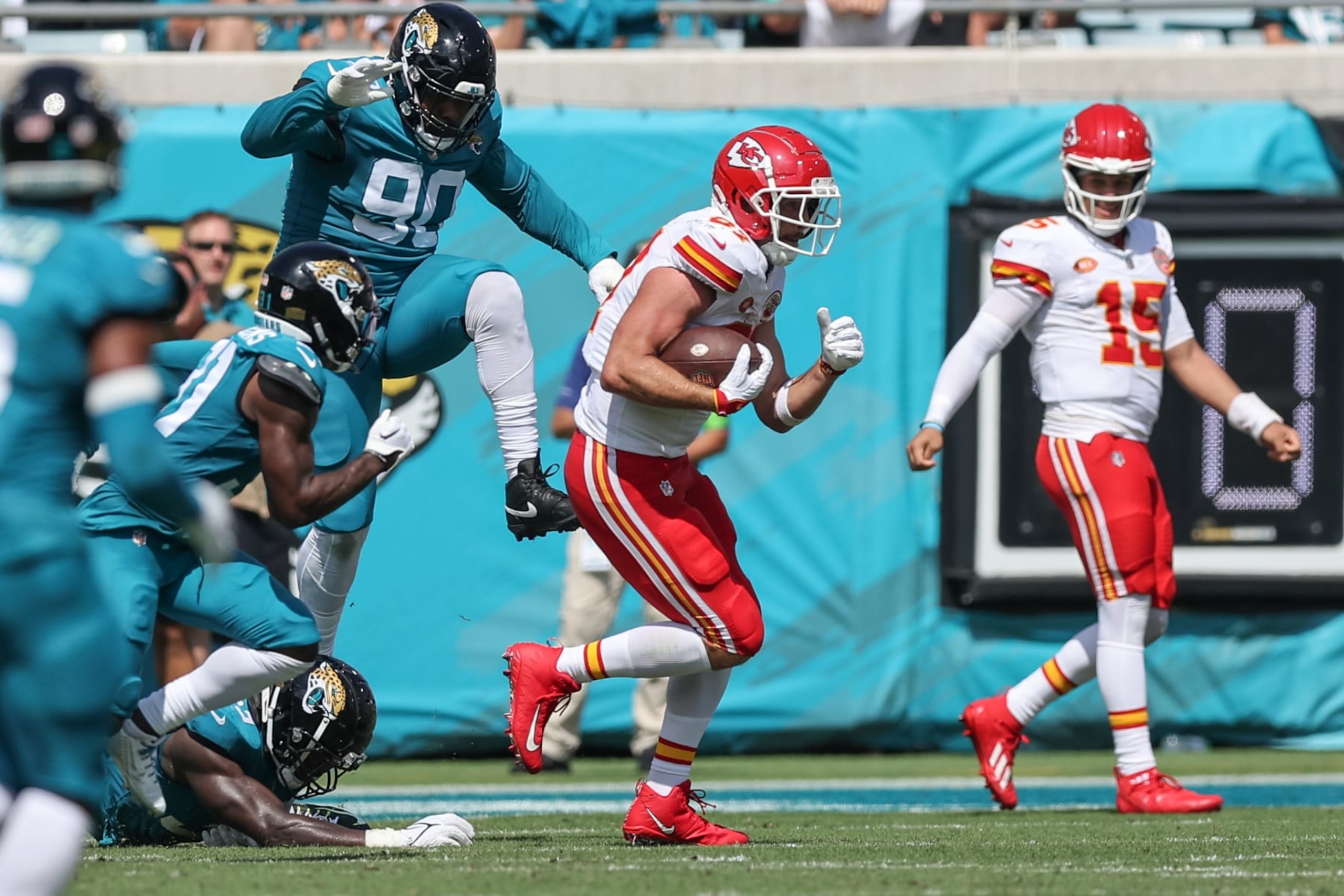 JACKSONVILLE, FLORIDA - SEPTEMBER 17: Travis Kelce #87 of the Kansas City Chiefs runs away from Angelo Blackson #90 of the Jacksonville Jaguars at EverBank Field on September 17, 2023 in Jacksonville, Florida. (Photo by Mike Carlson/Getty Images)