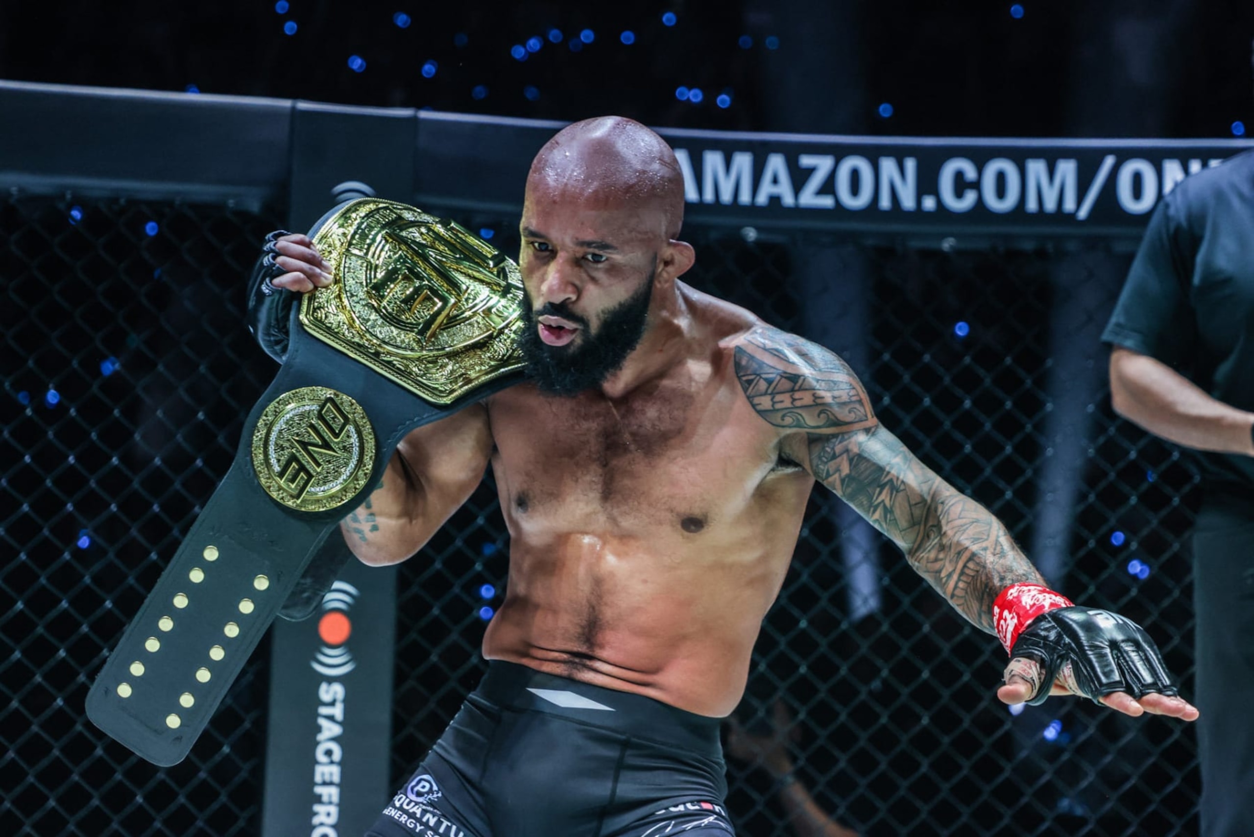 ONE flyweight MMA champion Demetrious Johnson hoists his title at ONE Fight Night 10 in Denver. ONE flyweight MMA champion Demetrious Johnson hoists his title at ONE Fight Night 10 in Denver.
