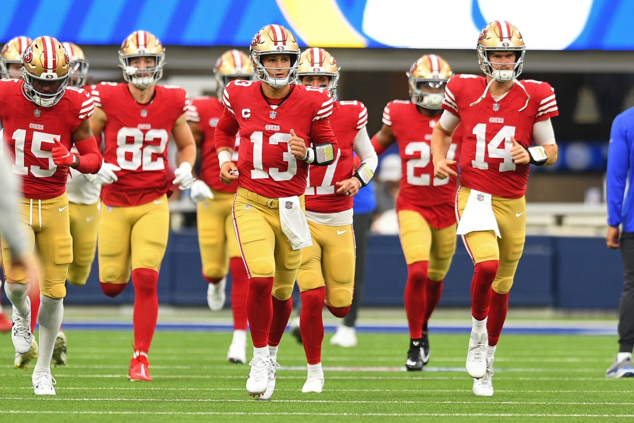 INGLEWOOD, CA - SEPTEMBER 17: San Francisco 49ers quarterback Brock Purdy (13) and San Francisco 49ers quarterback Sam Darnold (14) lead the team out to the field before the NFL game between the San Francisco 49ers and the Los Angeles Rams on September 17, 2023, at SoFi Stadium in Inglewood, CA. (Photo by Brian Rothmuller/Icon Sportswire via Getty Images)