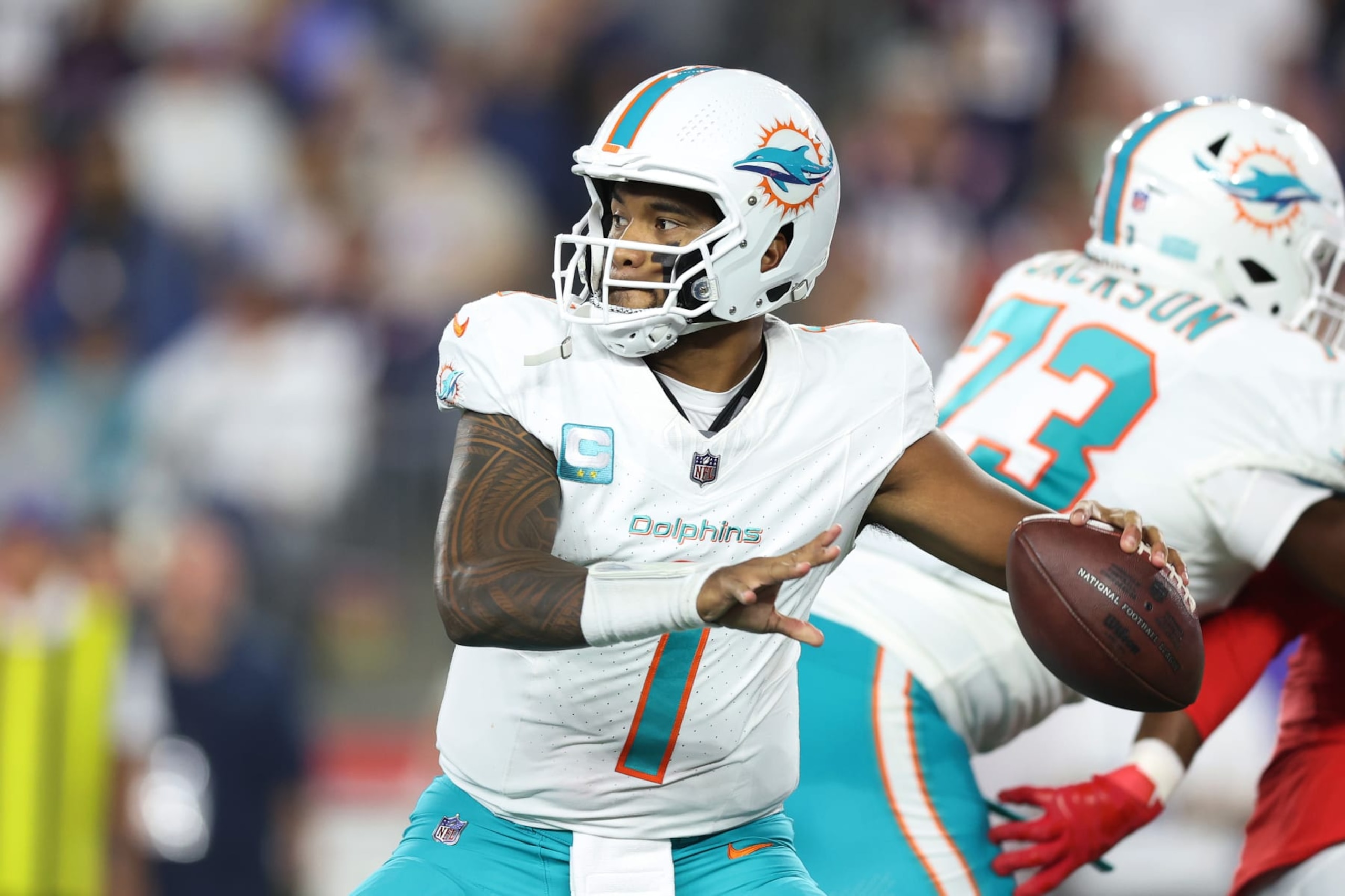 FOXBOROUGH, MASSACHUSETTS - SEPTEMBER 17: Tua Tagovailoa #1 of the Miami Dolphins looks to pass against the New England Patriots at Gillette Stadium on September 17, 2023 in Foxborough, Massachusetts. (Photo by Adam Glanzman/Getty Images)