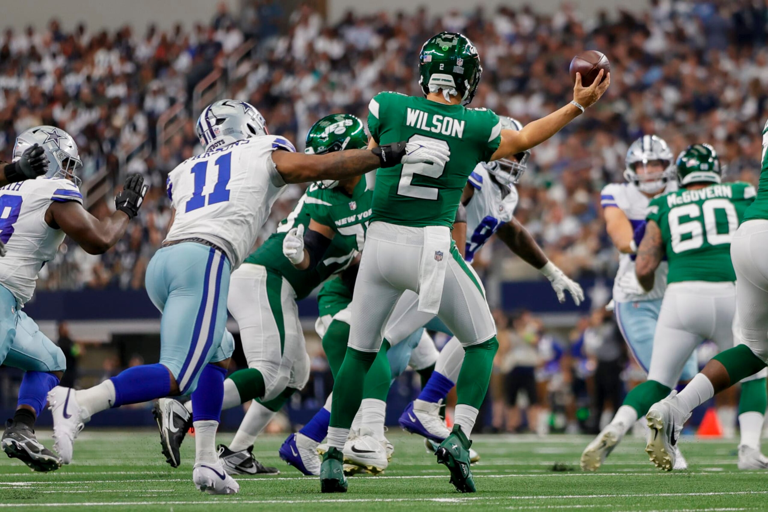 ARLINGTON, TX - SEPTEMBER 17: New York Jets quarterback Zach Wilson (2) gets pressured by Dallas Cowboys linebacker Micah Parsons (11) during the game between the Dallas Cowboys and the New York Jets on September 17, 2023 at AT&T Stadium in Arlington, Texas. (Photo by Matthew Pearce/Icon Sportswire via Getty Images)