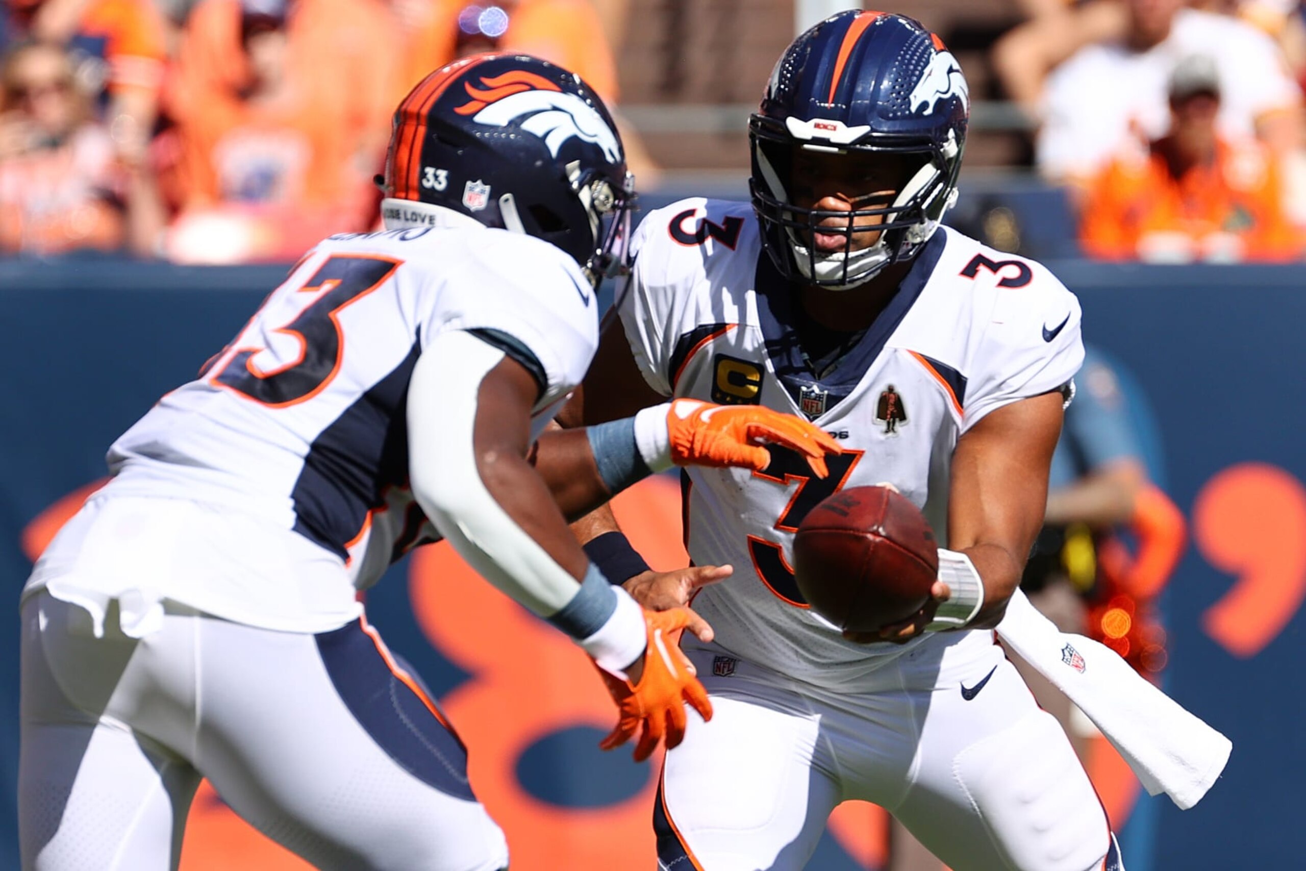 DENVER, COLORADO - SEPTEMBER 17: Russell Wilson #3 of the Denver Broncos hands the ball off to Javonte Williams #33 of the Denver Broncos during the first half against the Washington Commanders at Empower Field At Mile High on September 17, 2023 in Denver, Colorado. (Photo by Jamie Schwaberow/Getty Images)