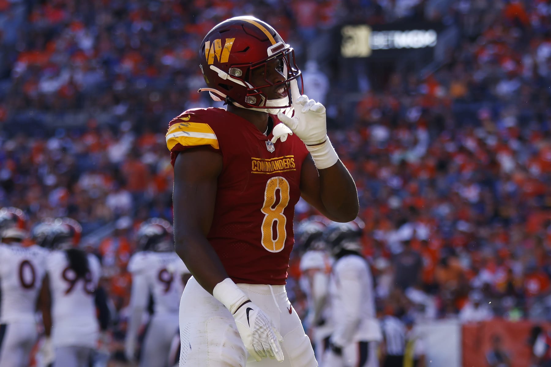 DENVER, COLORADO - SEPTEMBER 17: Brian Robinson Jr. #8 of the Washington Commanders celebrates after scoring a rushing touchdown during the fourth quarter against the Denver Broncos at Empower Field At Mile High on September 17, 2023 in Denver, Colorado. (Photo by Justin Edmonds/Getty Images)