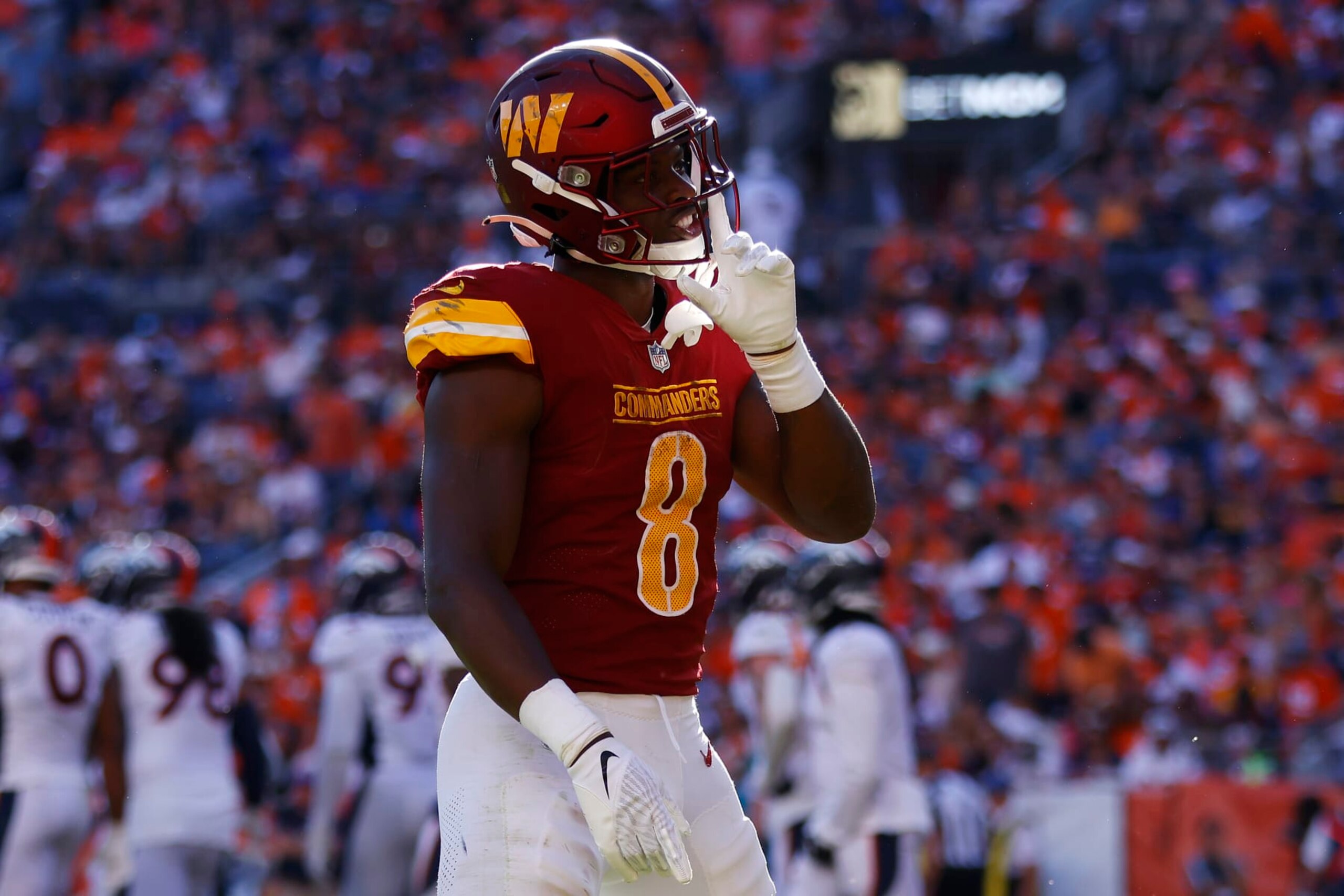 DENVER, COLORADO - SEPTEMBER 17: Brian Robinson Jr. #8 of the Washington Commanders celebrates after scoring a rushing touchdown during the fourth quarter against the Denver Broncos at Empower Field At Mile High on September 17, 2023 in Denver, Colorado. (Photo by Justin Edmonds/Getty Images)