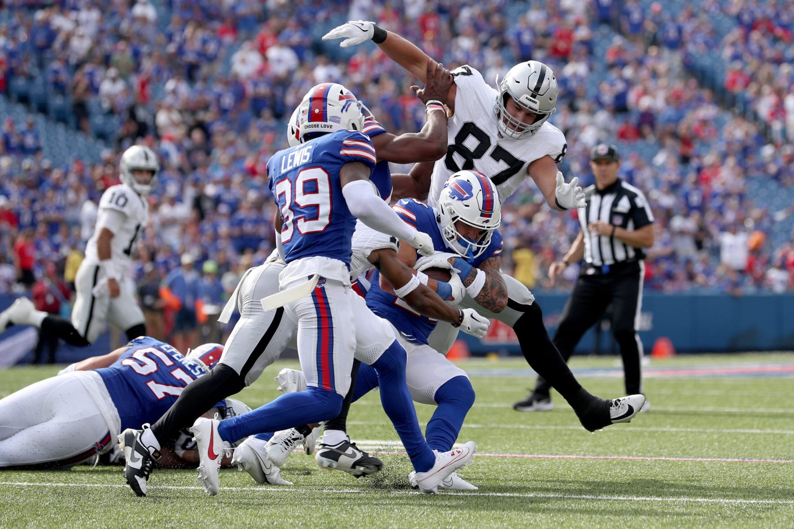 ORCHARD PARK, NEW YORK - SEPTEMBER 17: Michael Mayer #87 of the Las Vegas Raiders attempts to tackle Taylor Rapp #20 of the Buffalo Bills during the fourth quarter at Highmark Stadium on September 17, 2023 in Orchard Park, New York. (Photo by Bryan Bennett/Getty Images)