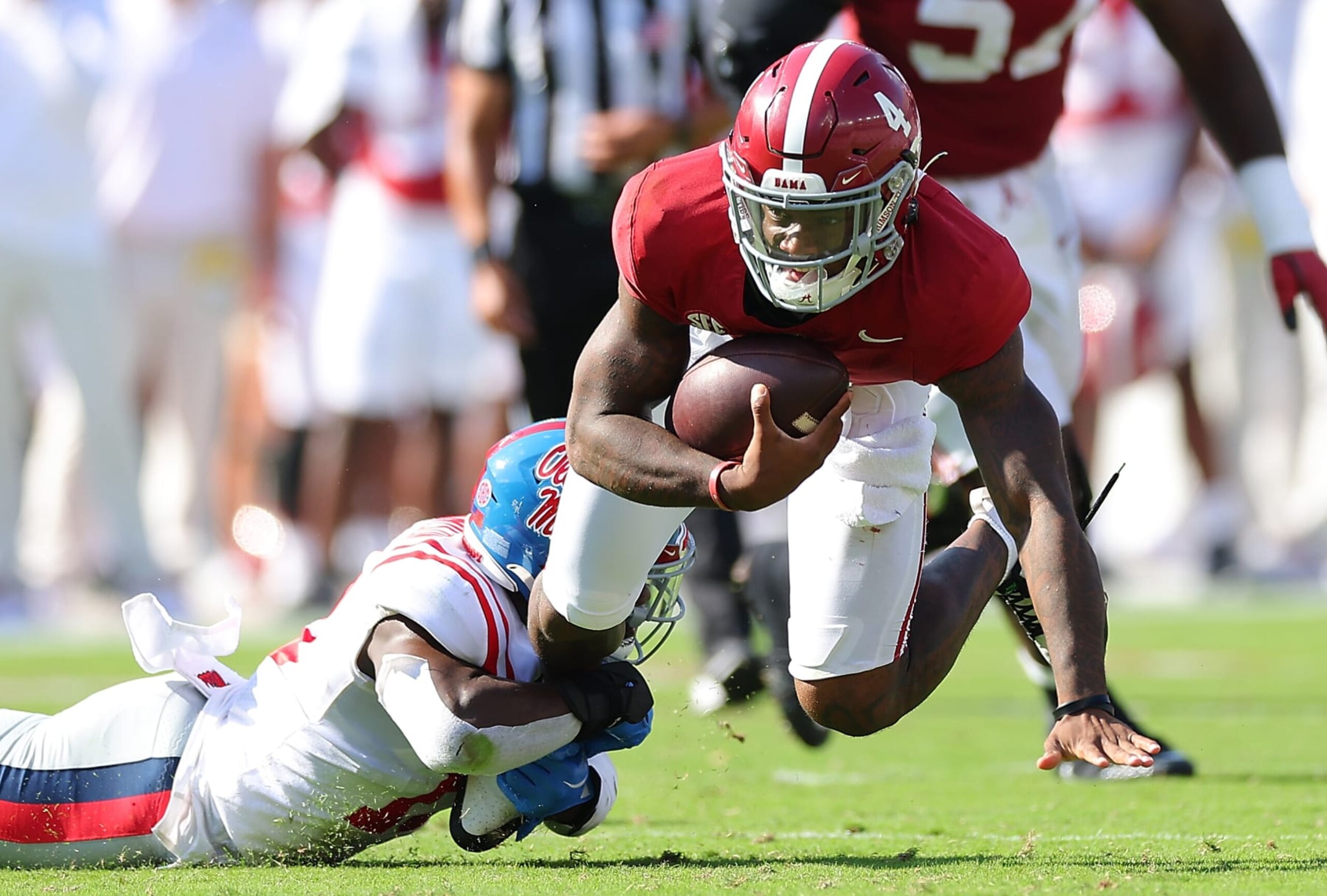 TUSCALOOSA, ALABAMA - SEPTEMBER 23:  Jalen Milroe #4 of the Alabama Crimson Tide is tackled by Ladarius Tennison #13 of the Mississippi Rebels during the second quarter at Bryant-Denny Stadium on September 23, 2023 in Tuscaloosa, Alabama. (Photo by Kevin C. Cox/Getty Images)