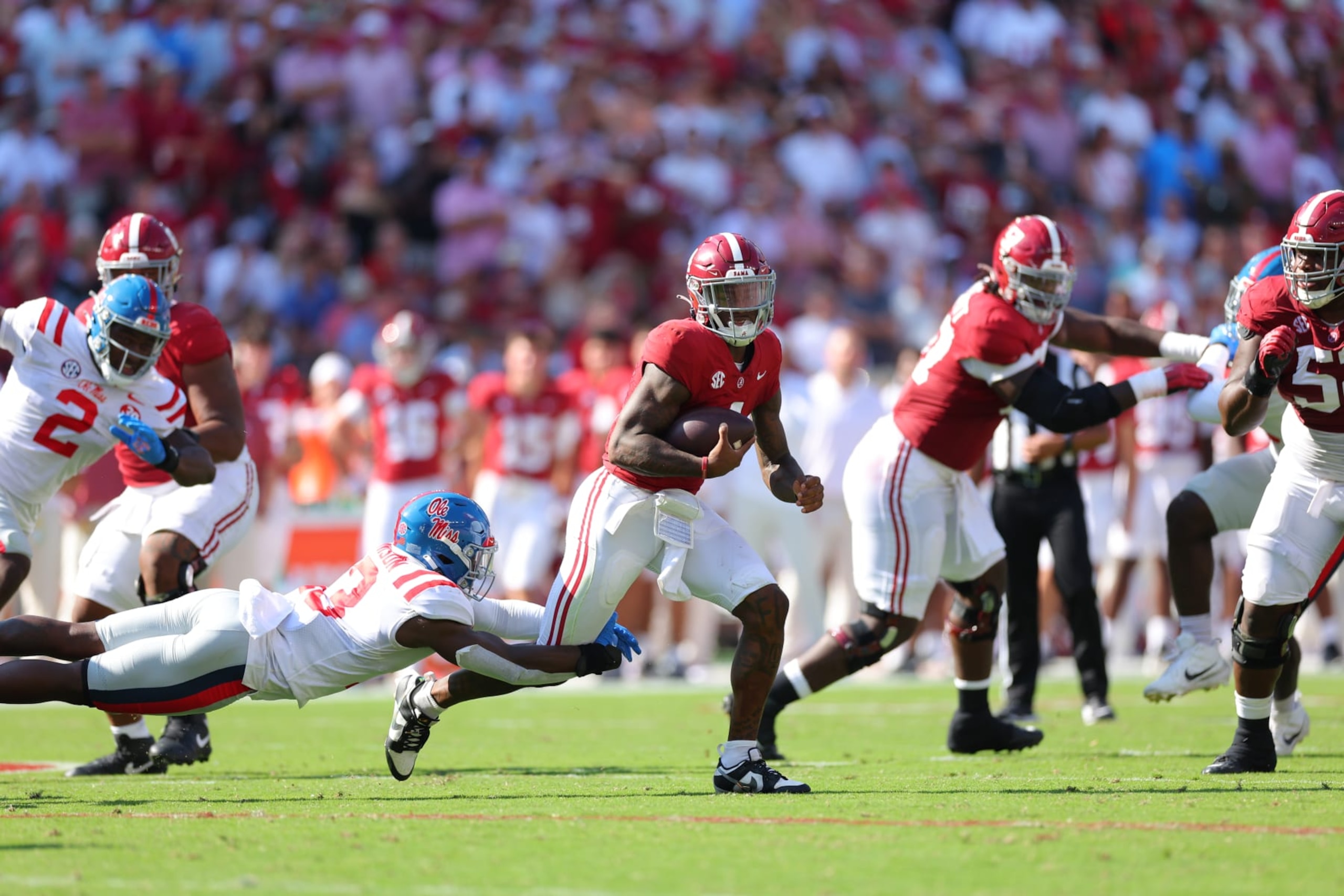 TUSCALOOSA, ALABAMA - SEPTEMBER 23:  Jalen Milroe #4 of the Alabama Crimson Tide is tackled by Ladarius Tennison #13 of the Mississippi Rebels during the second quarter at Bryant-Denny Stadium on September 23, 2023 in Tuscaloosa, Alabama. (Photo by Kevin C. Cox/Getty Images)