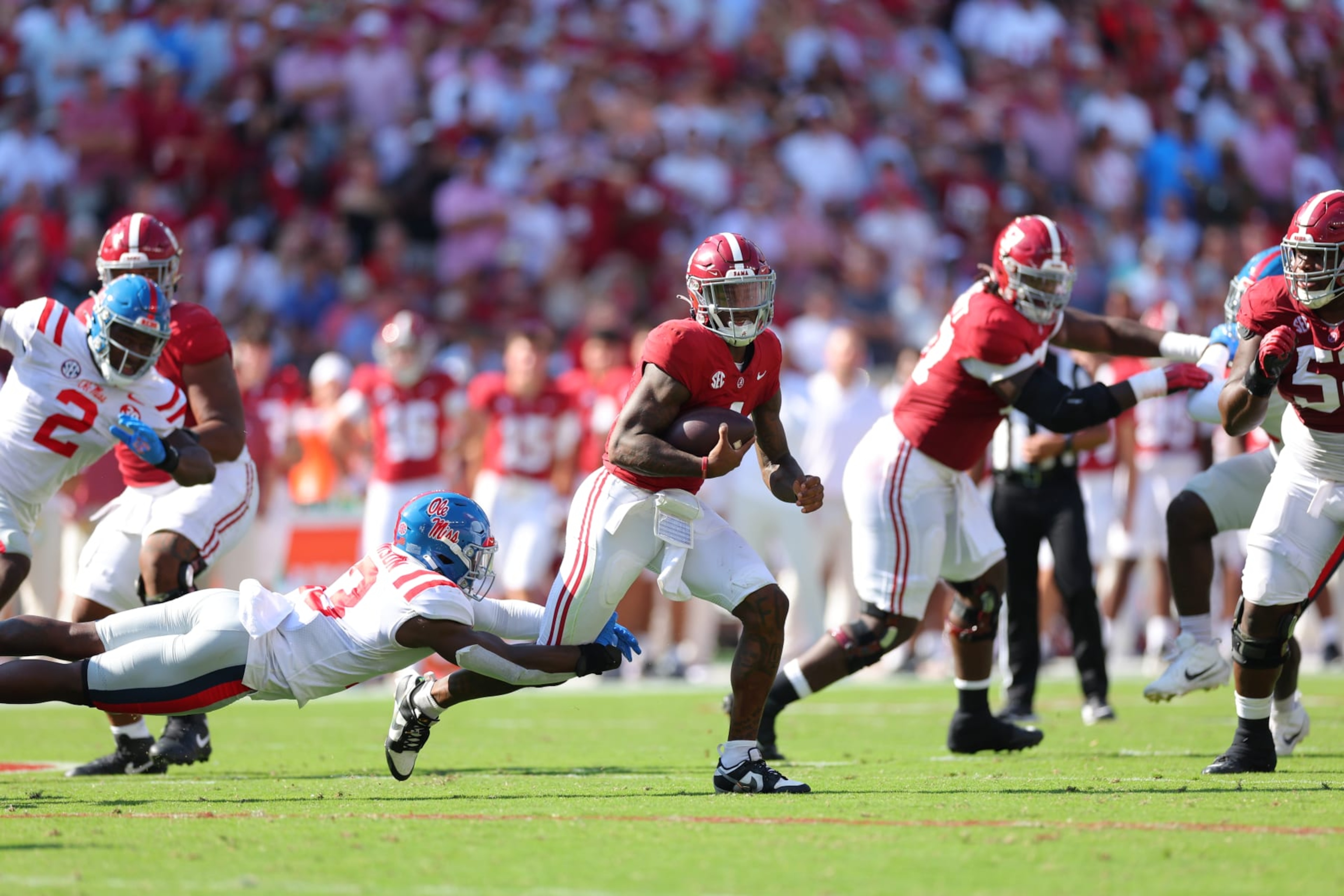 TUSCALOOSA, ALABAMA - SEPTEMBER 23:  Jalen Milroe #4 of the Alabama Crimson Tide is tackled by Ladarius Tennison #13 of the Mississippi Rebels during the second quarter at Bryant-Denny Stadium on September 23, 2023 in Tuscaloosa, Alabama. (Photo by Kevin C. Cox/Getty Images)