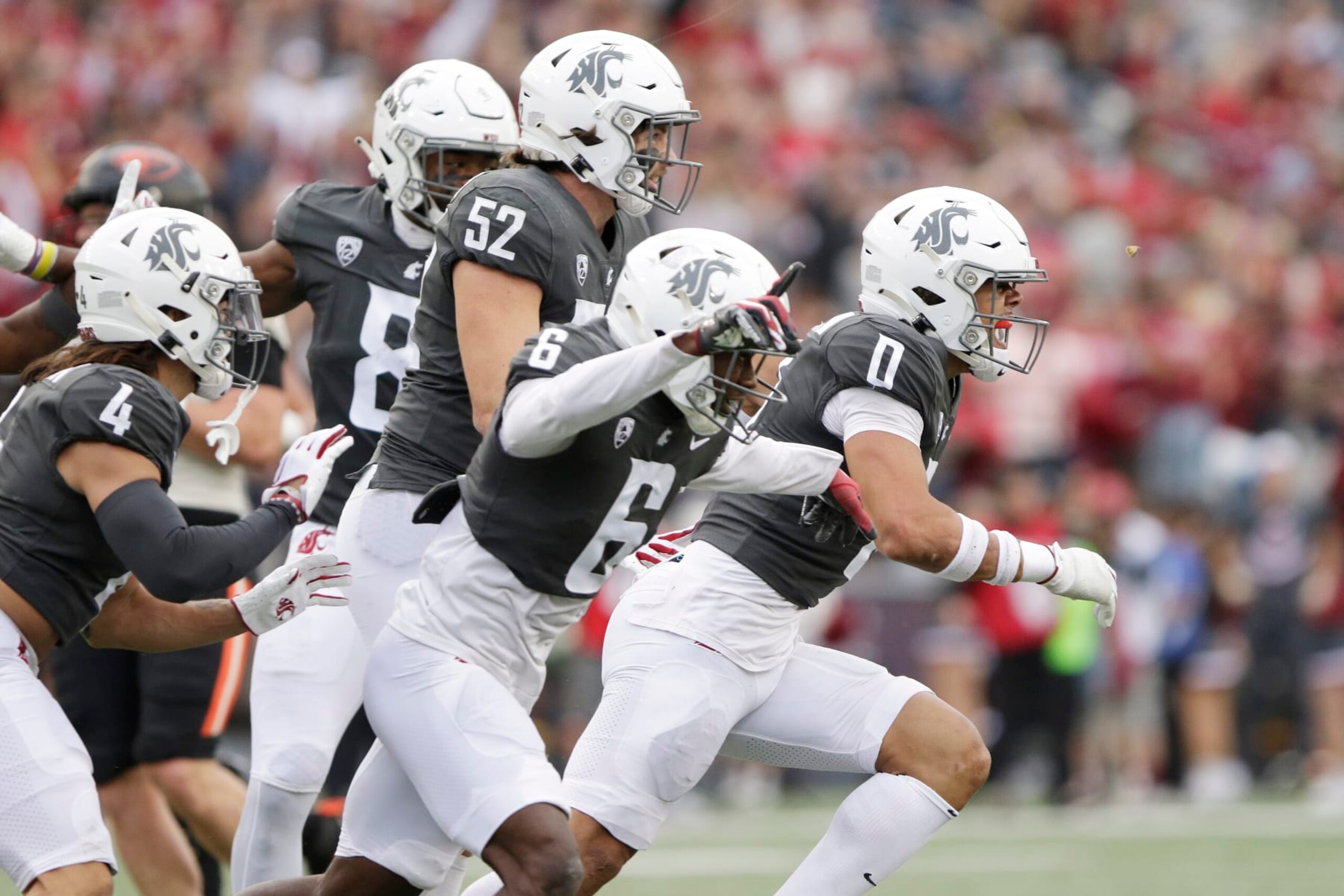 Washington State defensive back Sam Lockett III (0) celebrates intercepting an Oregon State pass with teammates during the first half of an NCAA college football game, Saturday, Sept. 23, 2023, in Pullman, Wash. (AP Photo/Young Kwak)