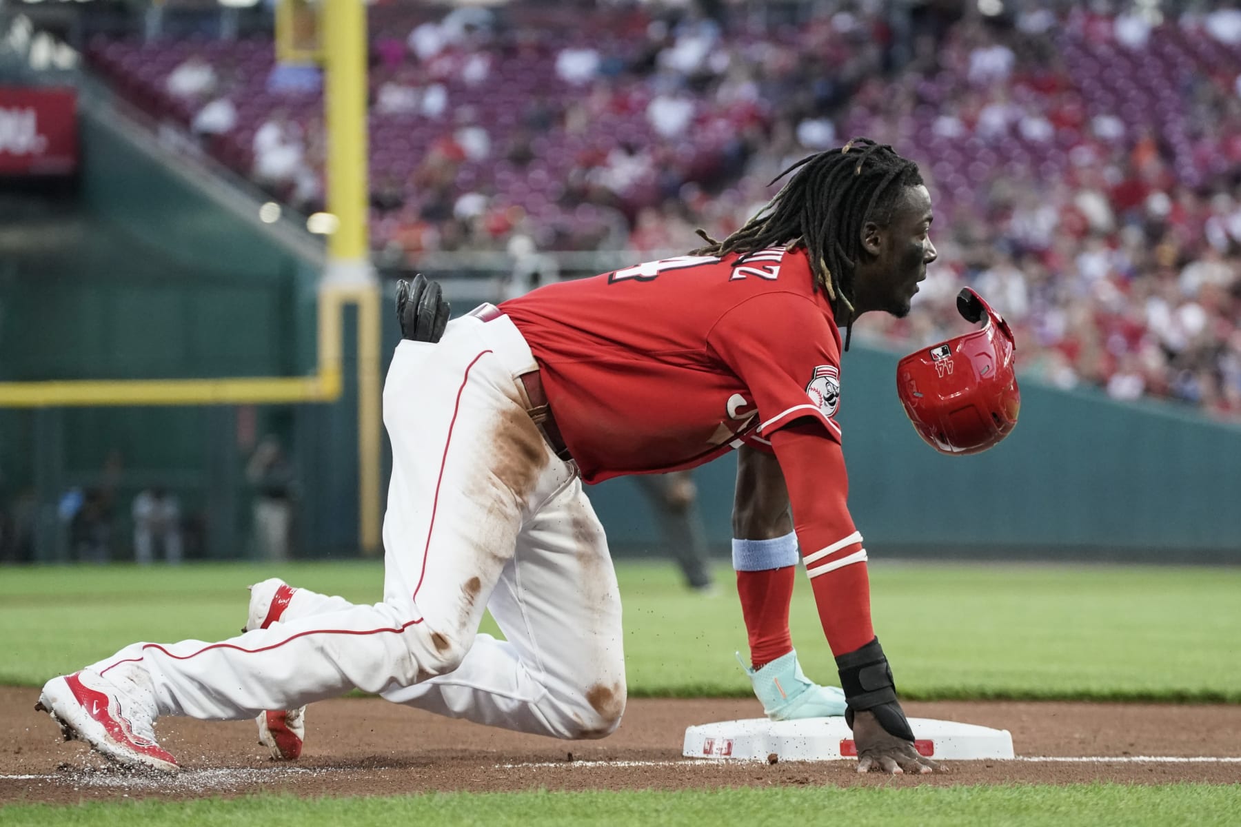 Cincinnati Reds' Elly De La Cruz loses his helmet after stealing third base during the second inning of the team's baseball game against the Pittsburgh Pirates, Saturday, Sept. 23, 2023, in Cincinnati. (AP Photo/Joshua A. Bickel) Cincinnati Reds' Elly De La Cruz loses his helmet after stealing third base during the second inning of the team's baseball game against the Pittsburgh Pirates, Saturday, Sept. 23, 2023, in Cincinnati. (AP Photo/Joshua A. Bickel)