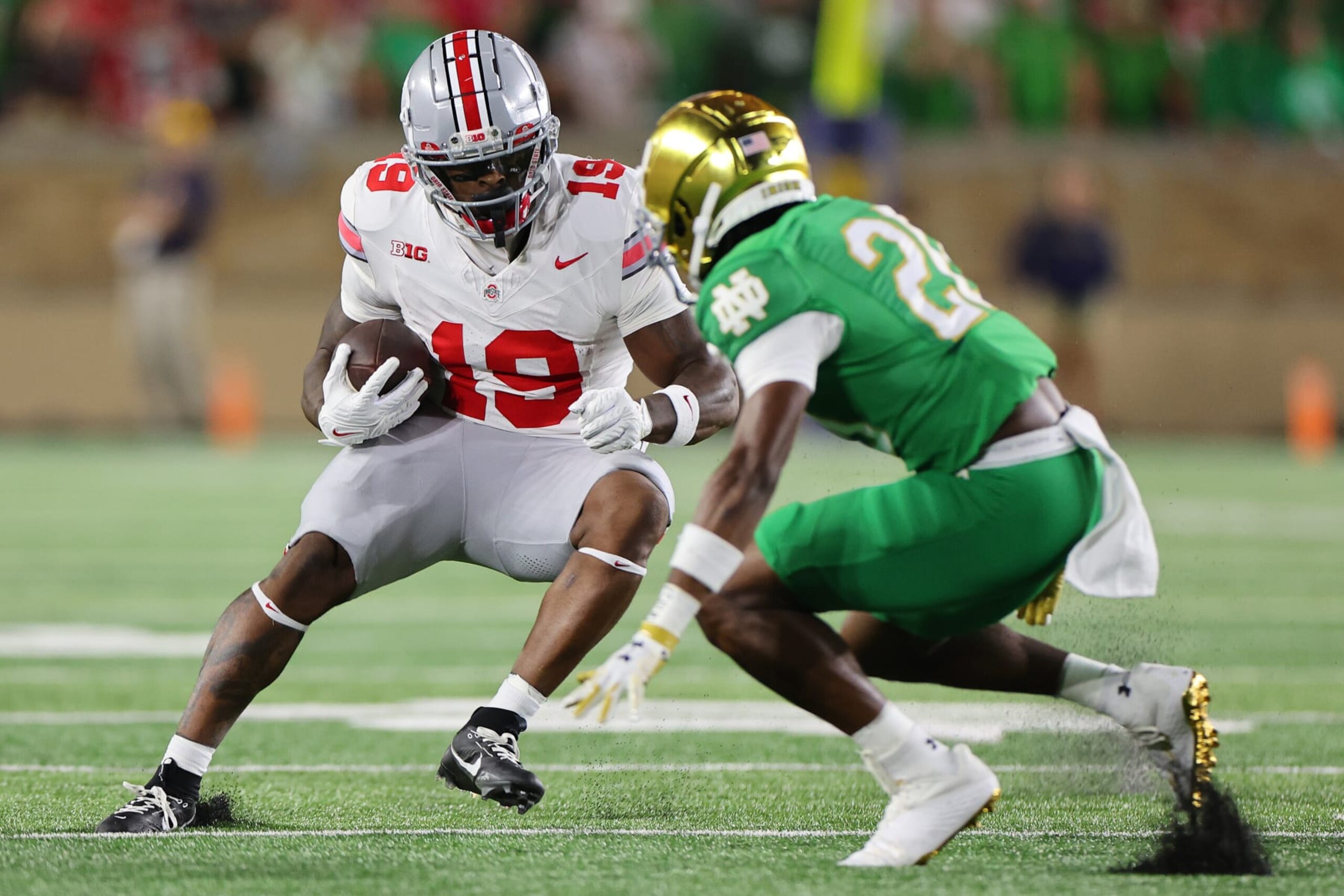 SOUTH BEND, INDIANA - SEPTEMBER 23: Chip Trayanum #19 of the Ohio State Buckeyes breaks a tackle from Benjamin Morrison #20 of the Notre Dame Fighting Irish during the first half at Notre Dame Stadium on September 23, 2023 in South Bend, Indiana. (Photo by Michael Reaves/Getty Images)