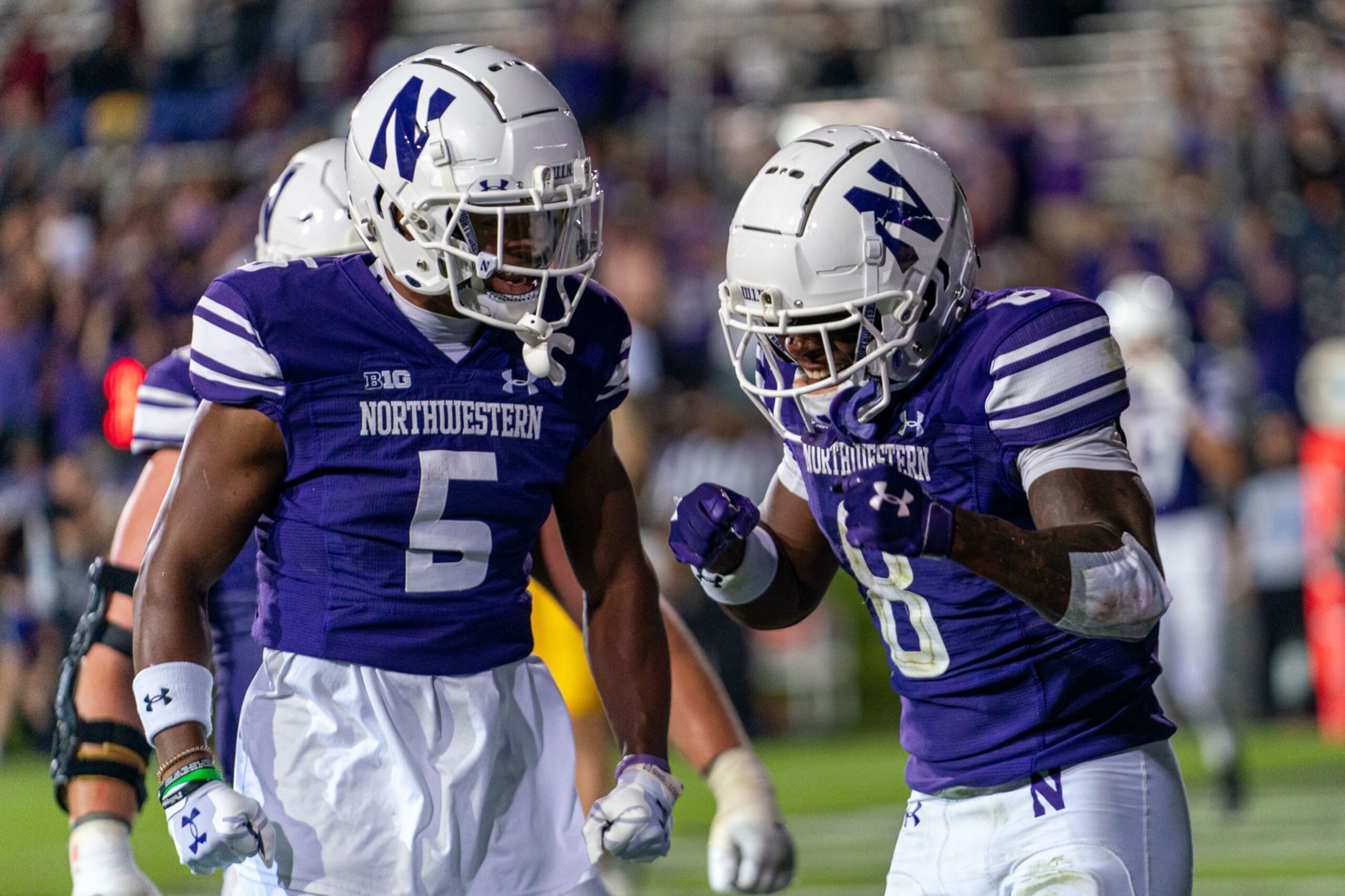 EVANSTON, IL - SEPTEMBER 23: Northwestern Wildcats wide receiver A.J. Henning (8) and Northwestern Wildcats wide receiver Jacob Gill (5) celebrate a touchdown made by Northwestern Wildcats wide receiver A.J. Henning (8) during the college football game between the Northwestern Wildcats and the Minnesota Golden Gophers on September 23, 2023, at Ryan Field in Evanston, IL (Photo by Ben Hsu/Icon Sportswire via Getty Images)