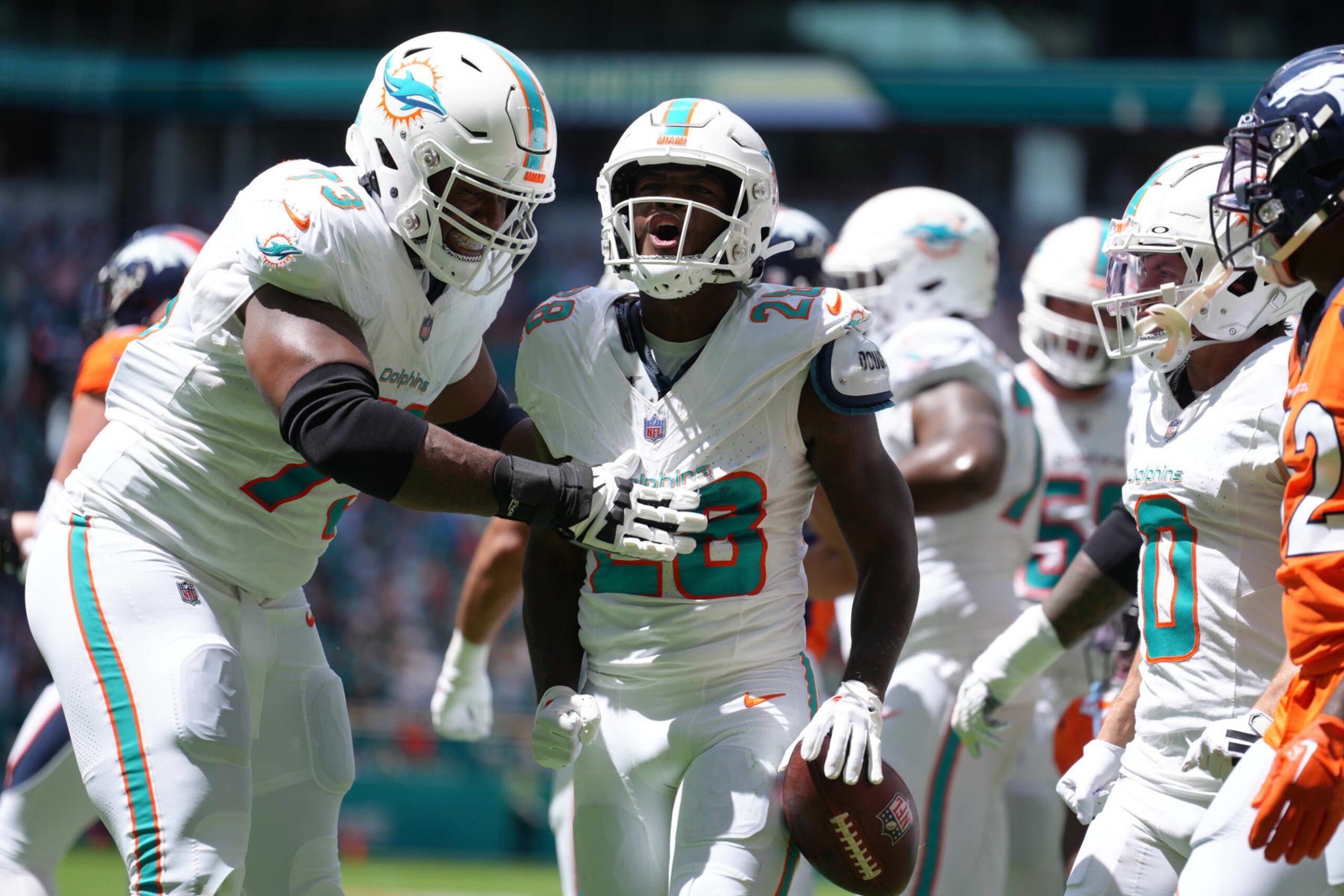 MIAMI GARDENS, FL - SEPTEMBER 24: Miami Dolphins running back De'Von Achane (28) celebrates his touchdown in the first half during the game between the Denver Broncos and the Miami Dolphins on Sunday, September 24, 2023 at Hard Rock Stadium, Miami, Fla. (Photo by Peter Joneleit/Icon Sportswire via Getty Images)