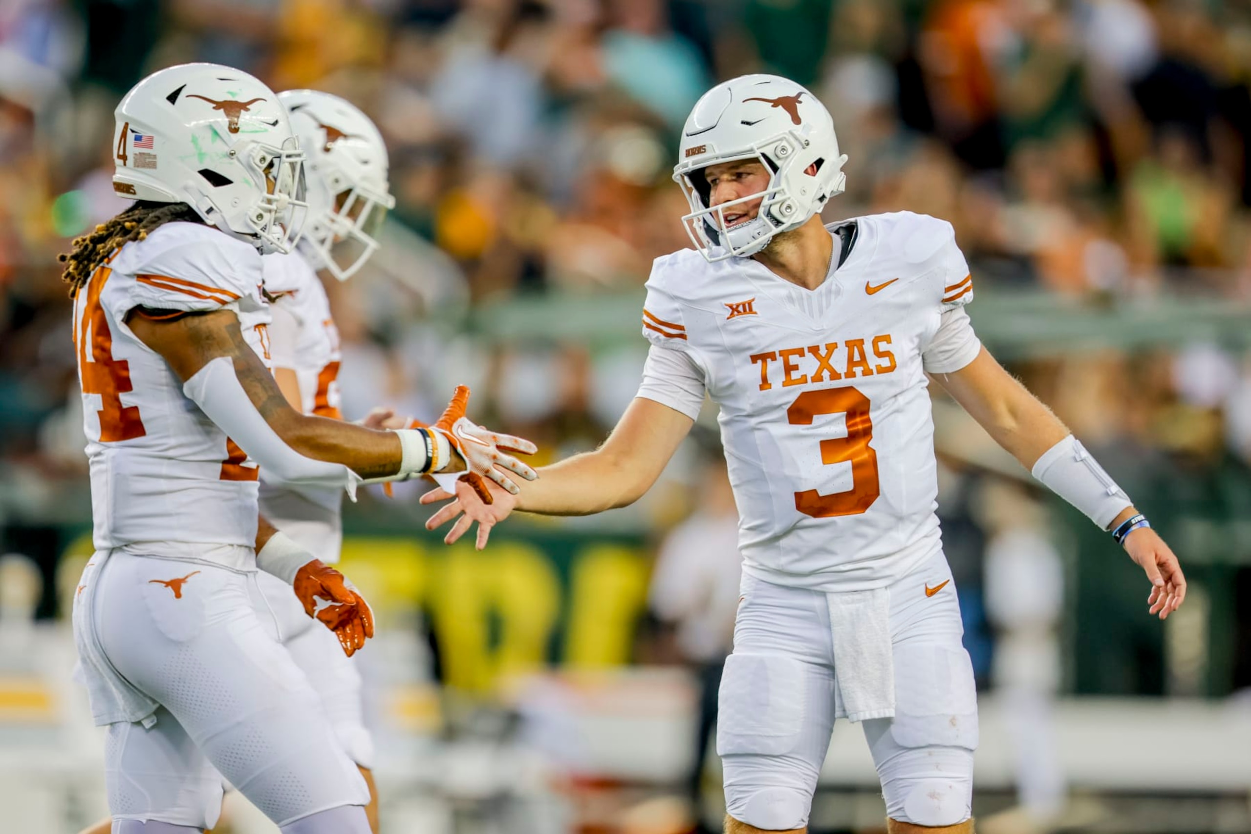 Texas quarterback Quinn Ewers (3) shakes hands with running back Jonathon Brooks during the first half of the team's NCAA college football game against Baylor, Saturday, Sept. 23, 2023, in Waco, Texas. (AP Photo/Gareth Patterson) Texas quarterback Quinn Ewers (3) shakes hands with running back Jonathon Brooks during the first half of the team's NCAA college football game against Baylor, Saturday, Sept. 23, 2023, in Waco, Texas. (AP Photo/Gareth Patterson)